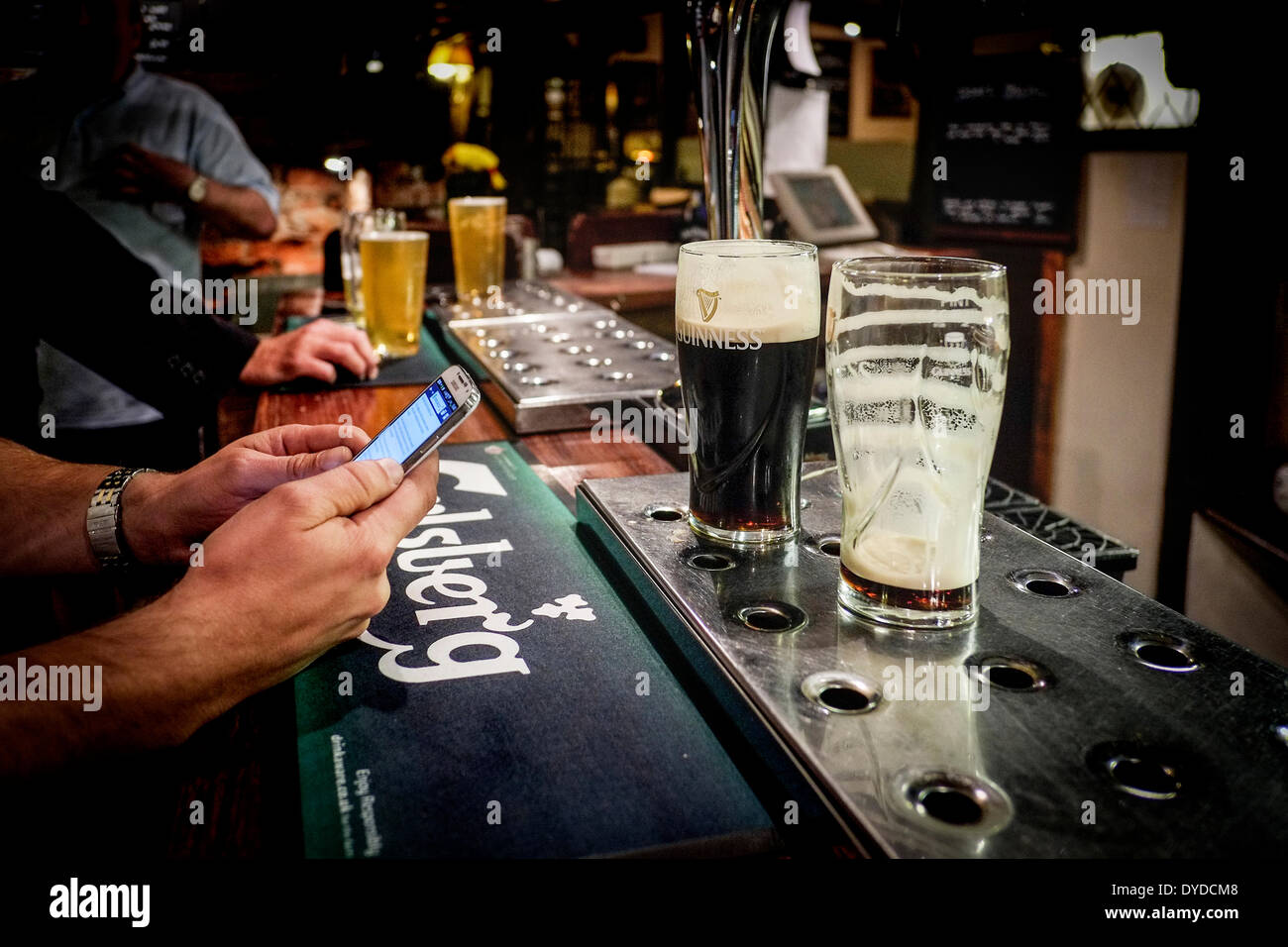 Pints of beer on the bar in a pub. Stock Photo
