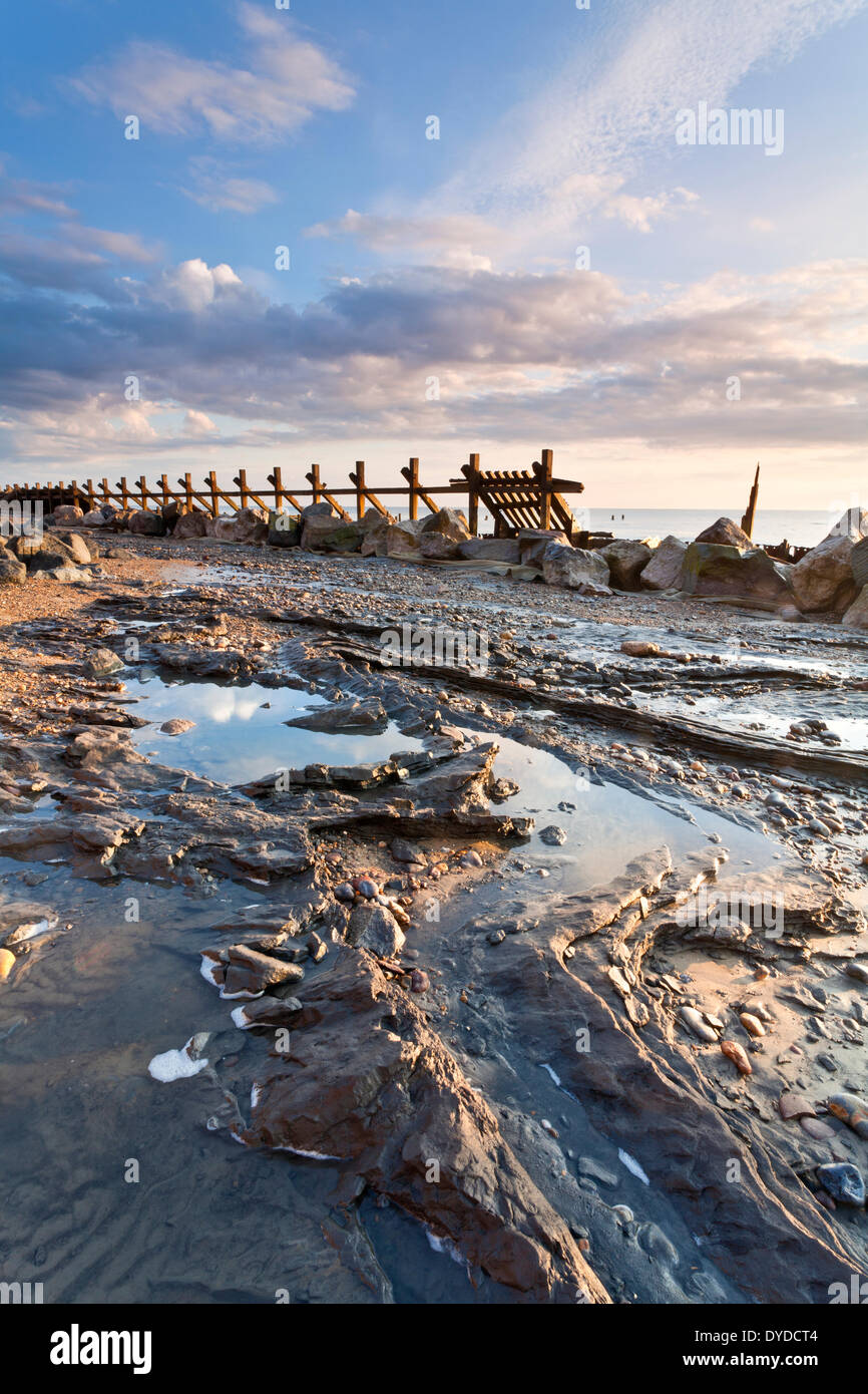 Happisburgh beach and the derelict sea defences at first light on the Norfolk coast. Stock Photo