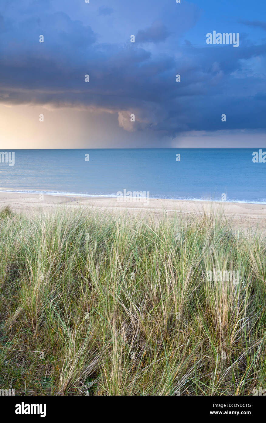 Sand dunes at Horsey and a dramatic summer storm out at sea. Stock Photo