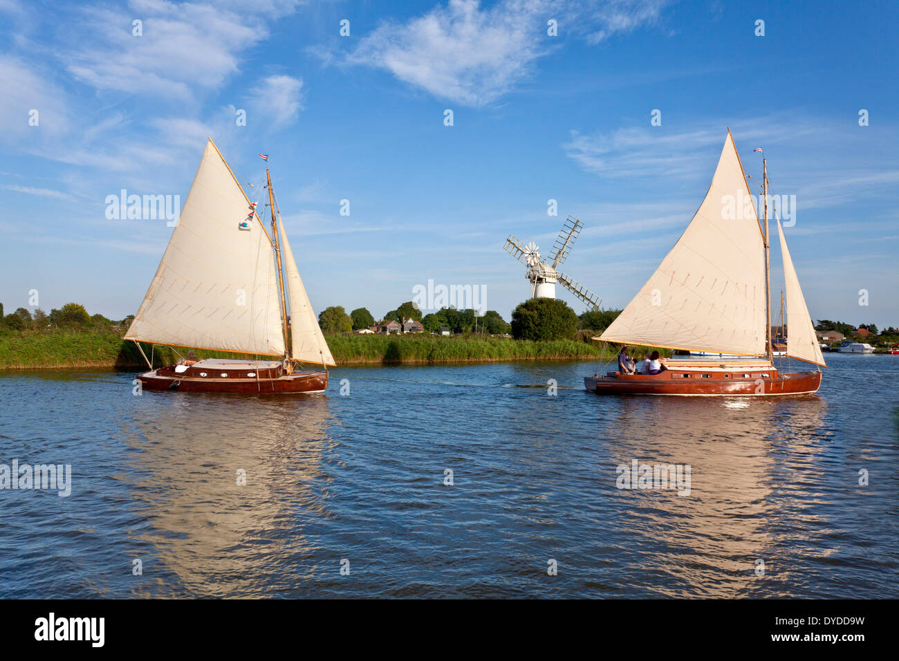 Wooden boats sail along the River Thurne. Stock Photo