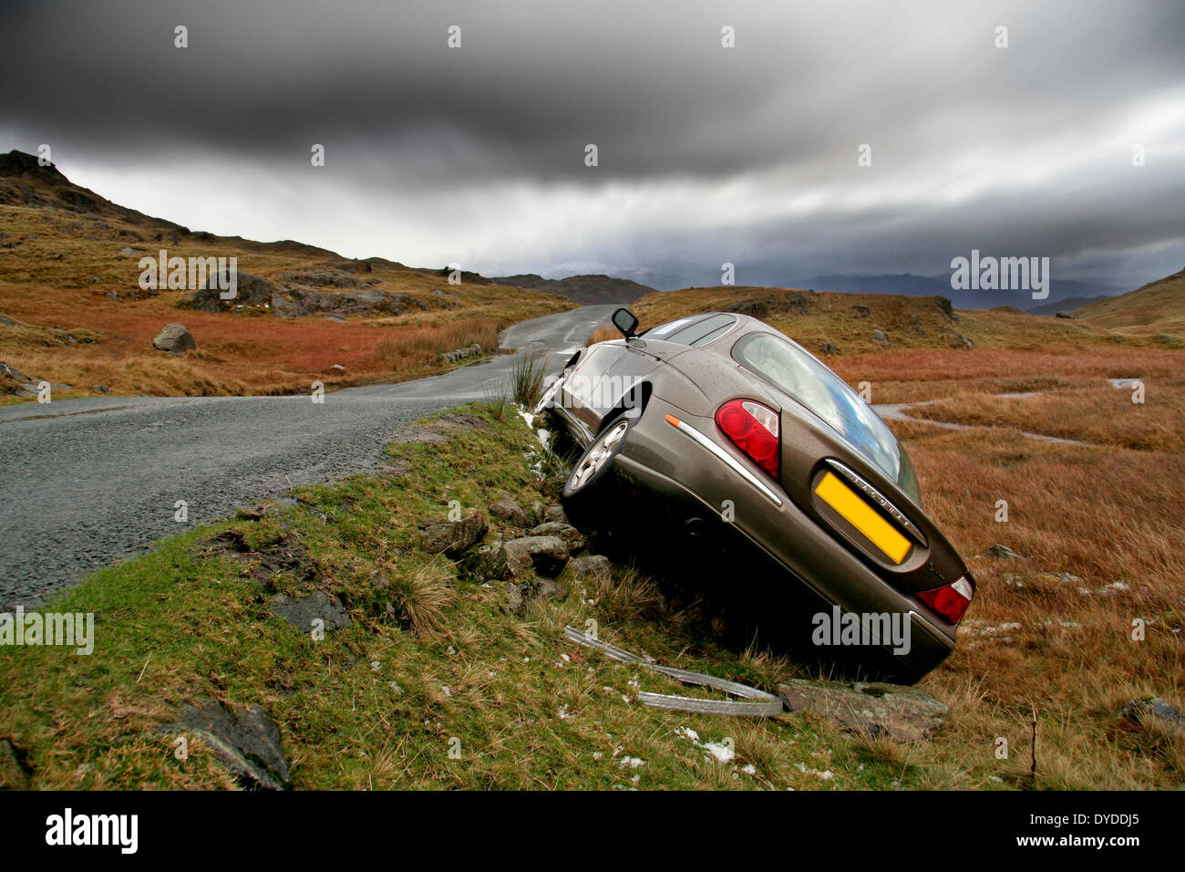 Crashed Jaguar S Type on Wrynose Pass in Cumbria. Stock Photo