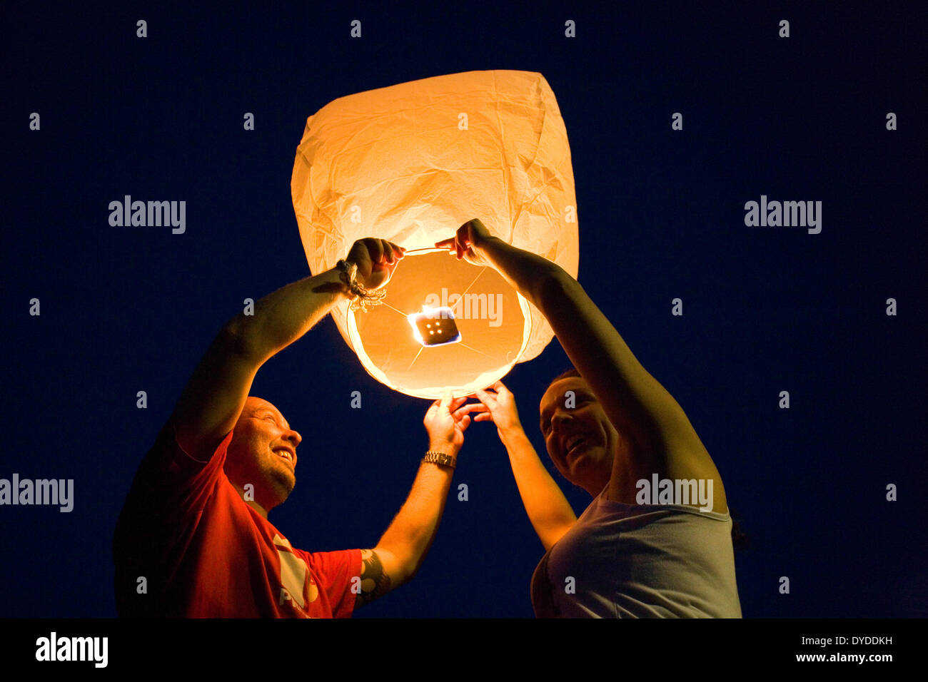 Residents at a street party releasing a chinese lantern. Stock Photo