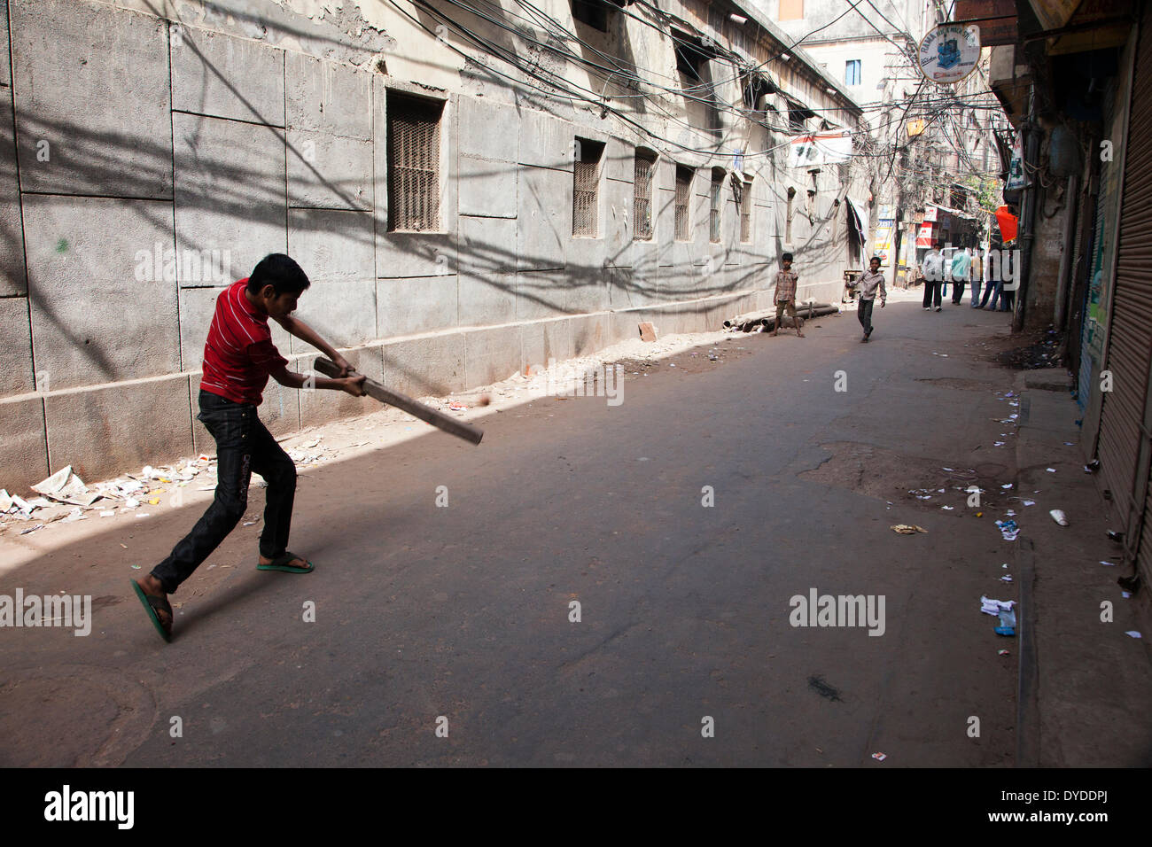 Boys playing cricket in the Old Delhi. Stock Photo
