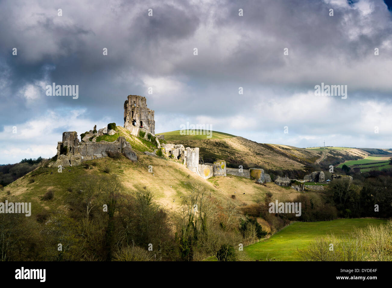 Corfe Castle in Dorset with storm clouds gathering above. Stock Photo