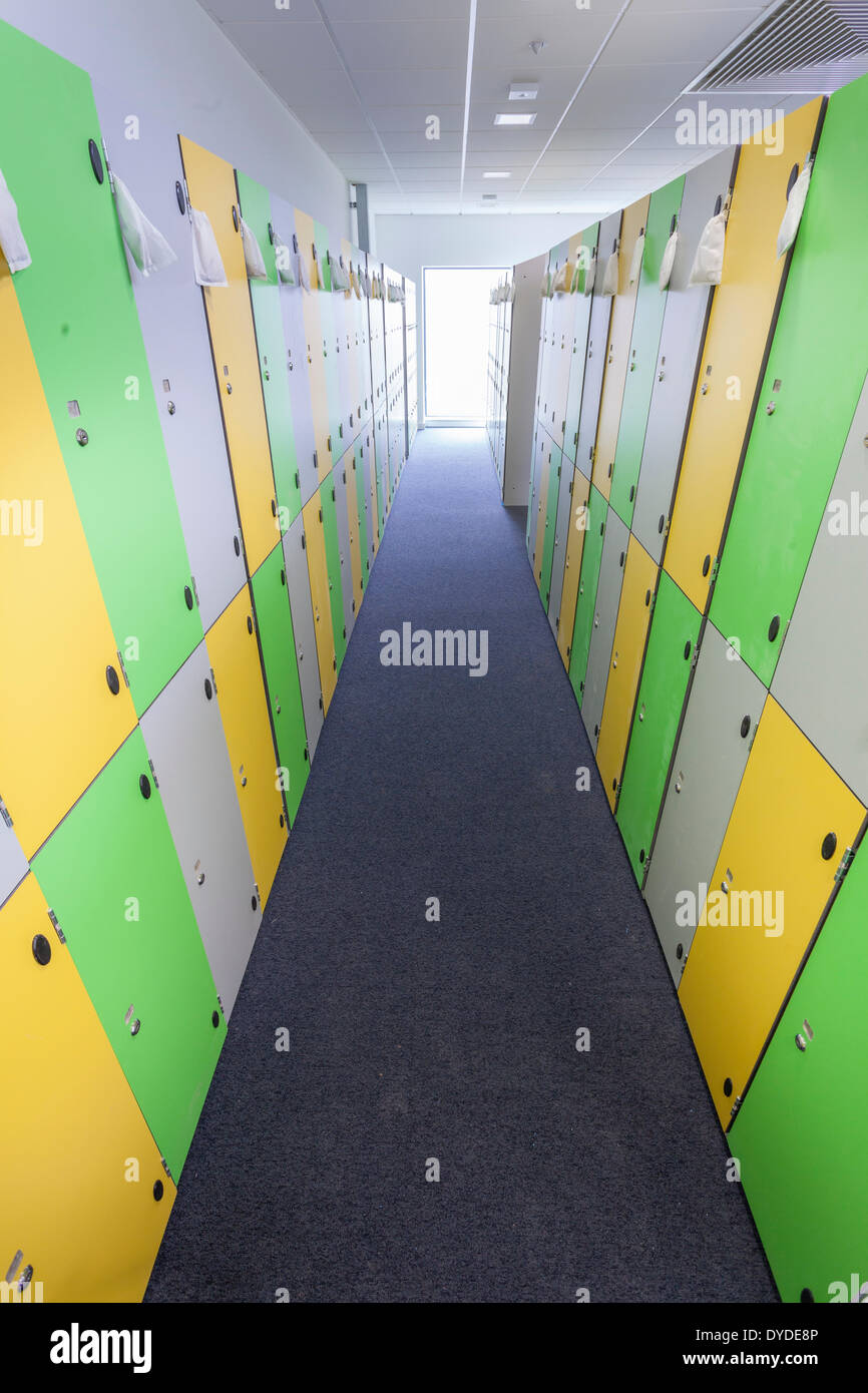 Rows of colourful school lockers in an unoccupied changing room. Stock Photo