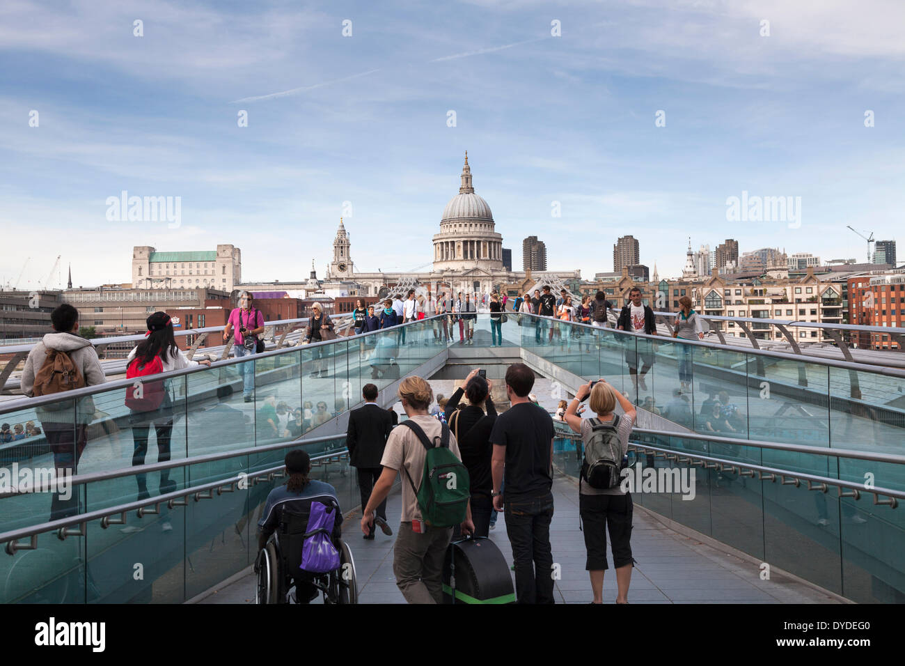 Tourists on the Millennium Bridge and South Facade of St Paul's Cathedral and dome. Stock Photo