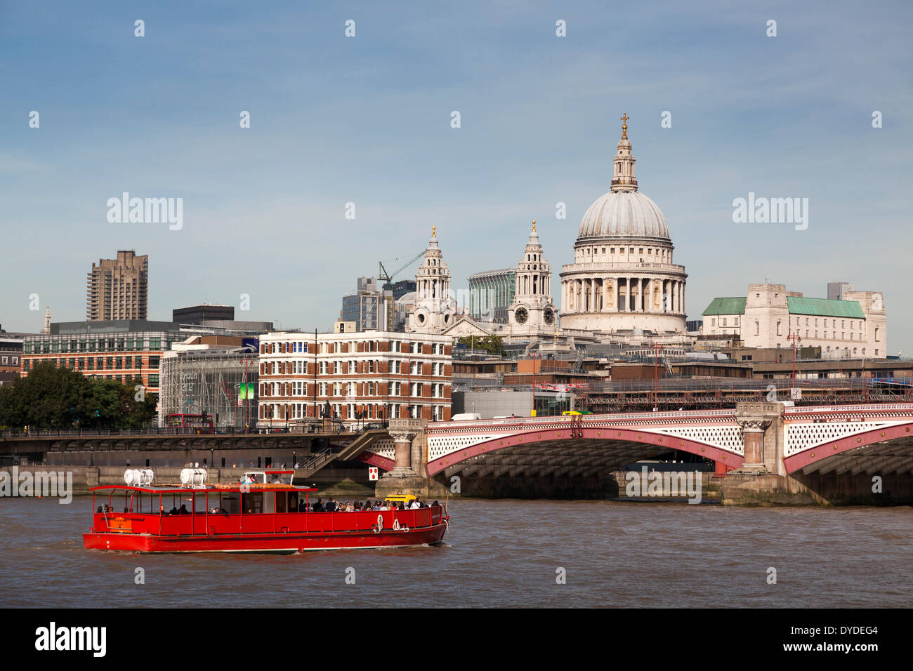 Red river cruiser on the River Thames and St Paul's Cathedral Dome. Stock Photo
