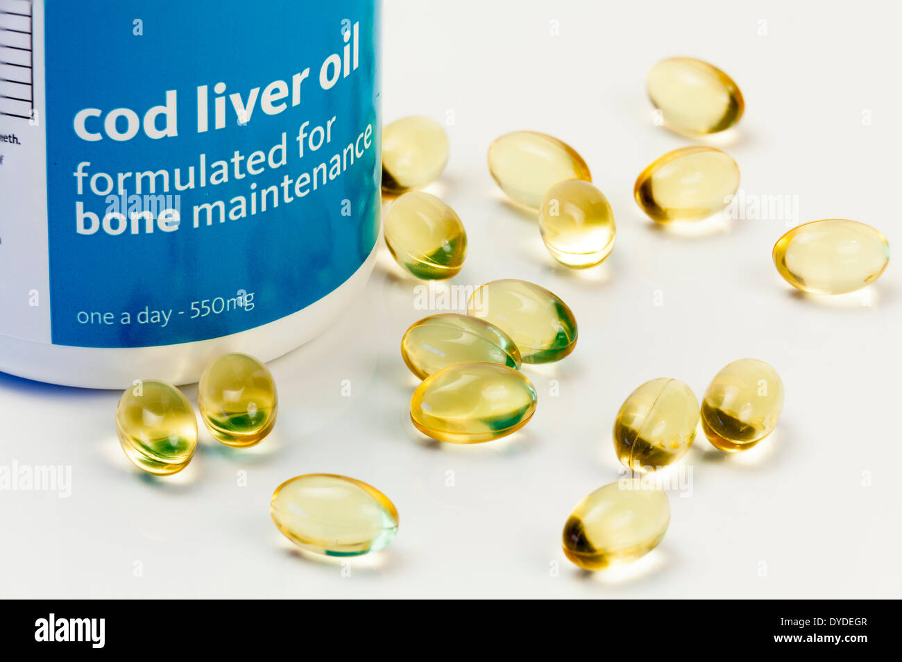 Close up studio still life of cod liver oil capsules and container. Stock Photo