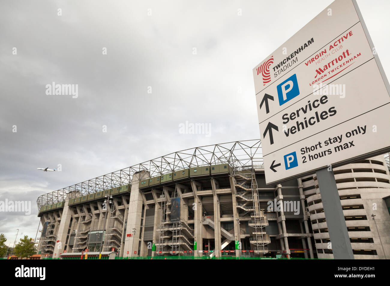 Twickenham stadium with parking information sign and aircraft. Stock Photo