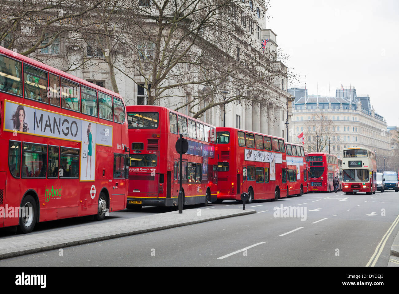Many red London double decker buses queuing to get into Trafalgar Square. Stock Photo