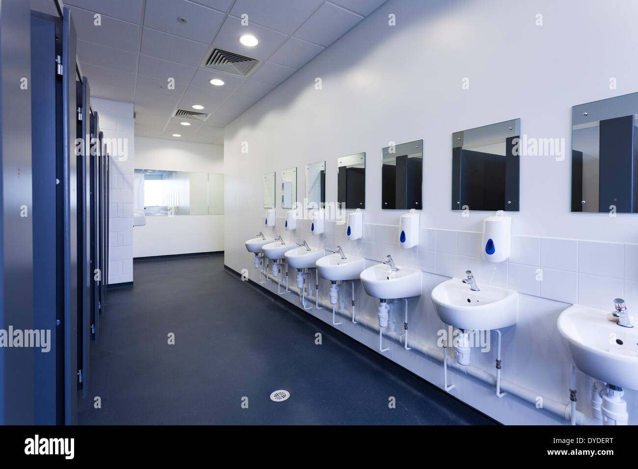 Unoccupied female public toilets with wash basins and mirrors. Stock Photo
