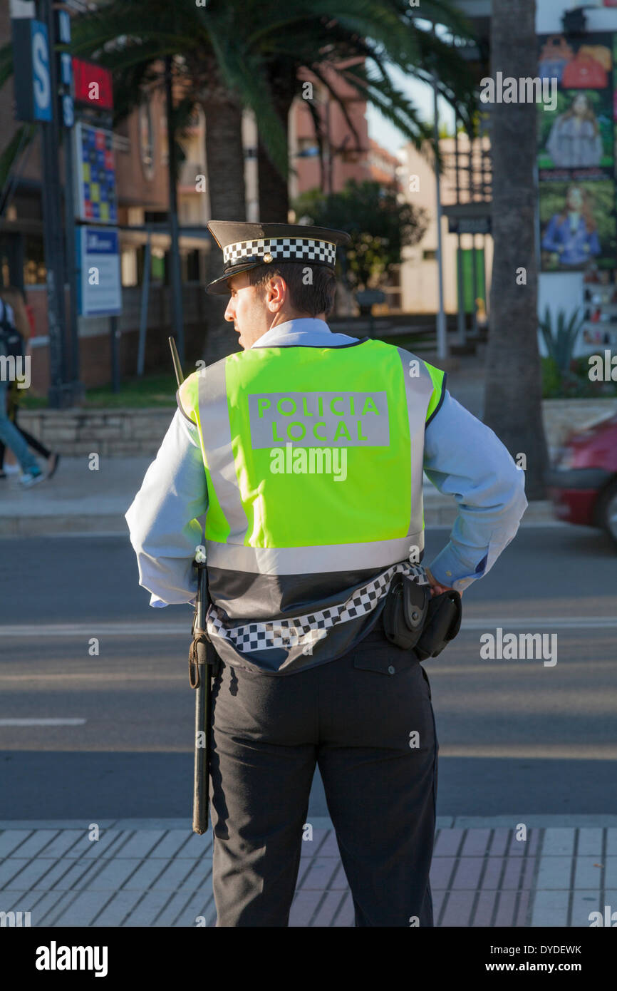 Back of policeman policia local looking to side. Stock Photo