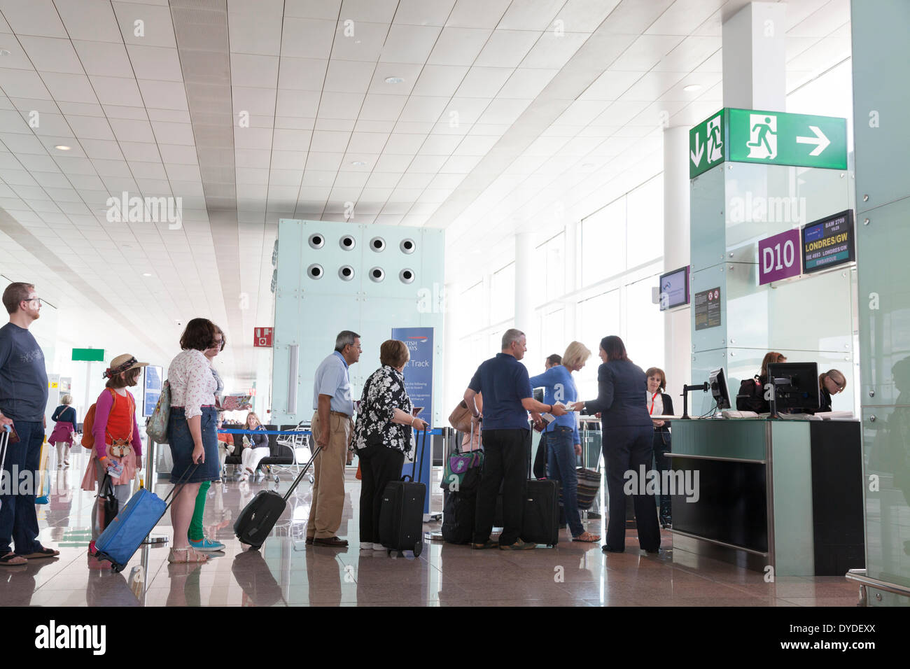 Passengers queuing to board at airport departure gate Stock Photo - Alamy