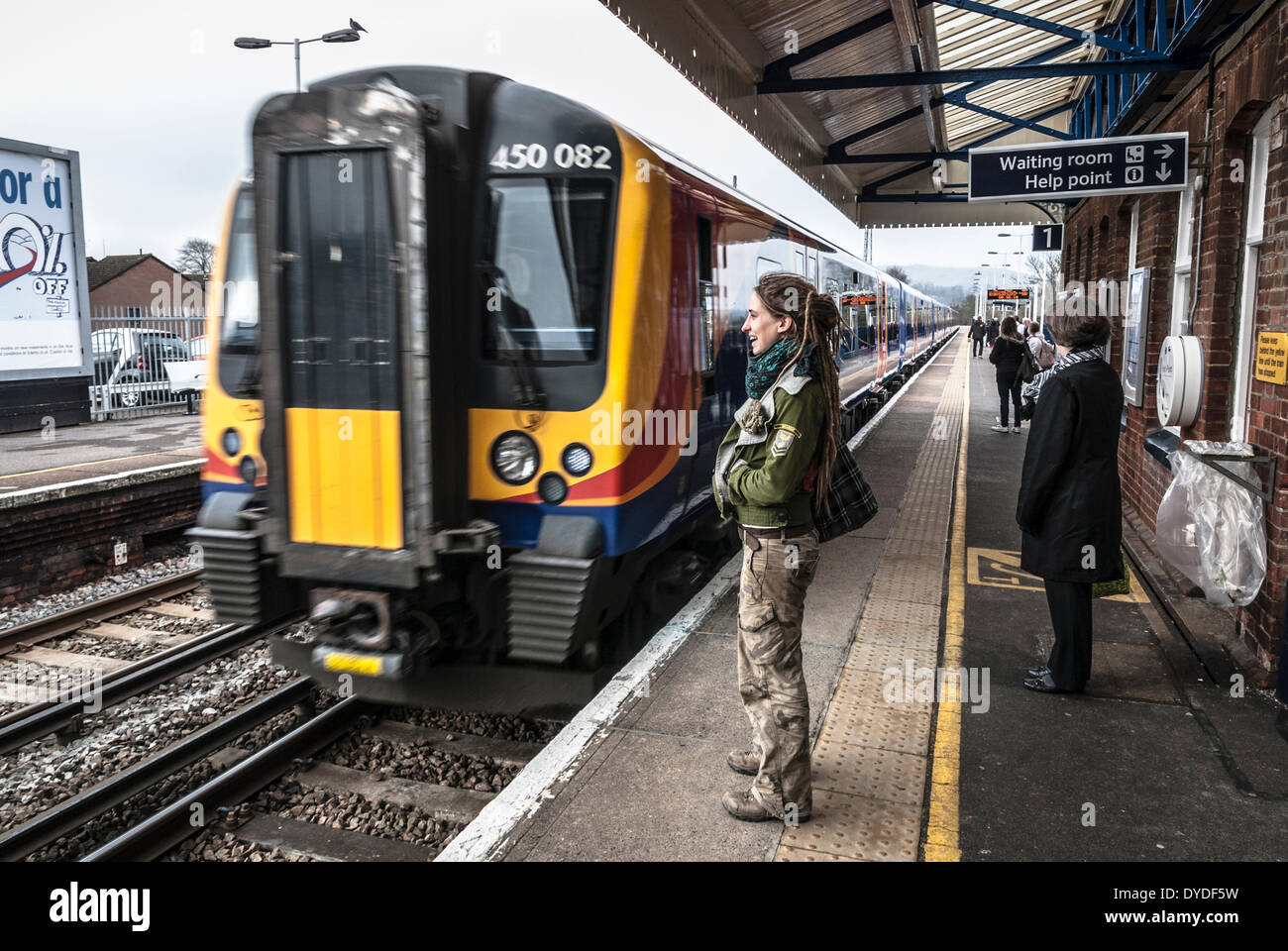 Passengers and approaching train at Petersfield railway station. Stock Photo