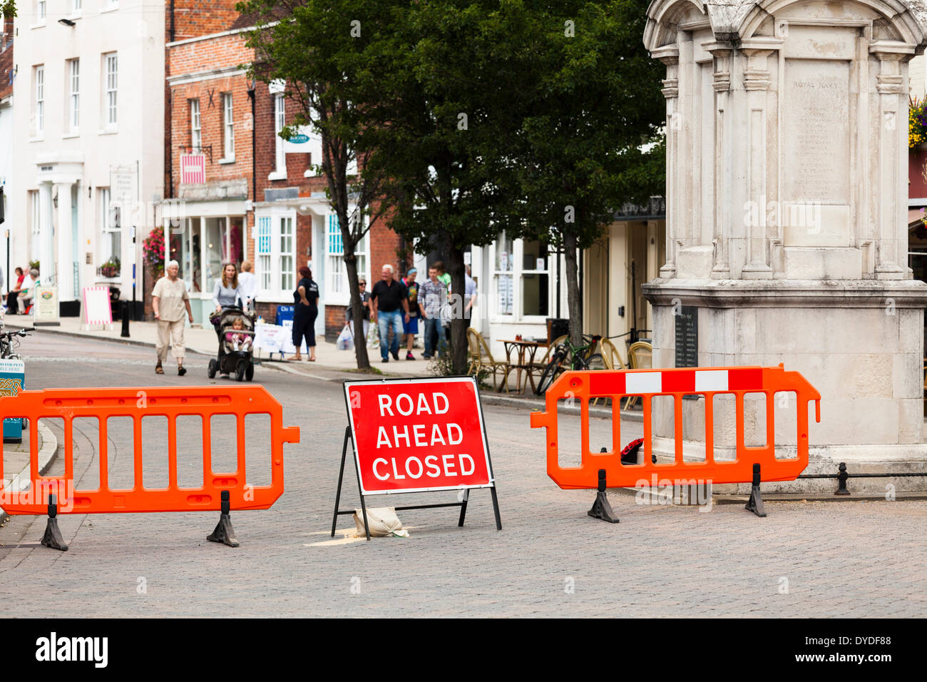 Road closed sign and barriers in town high street. Stock Photo