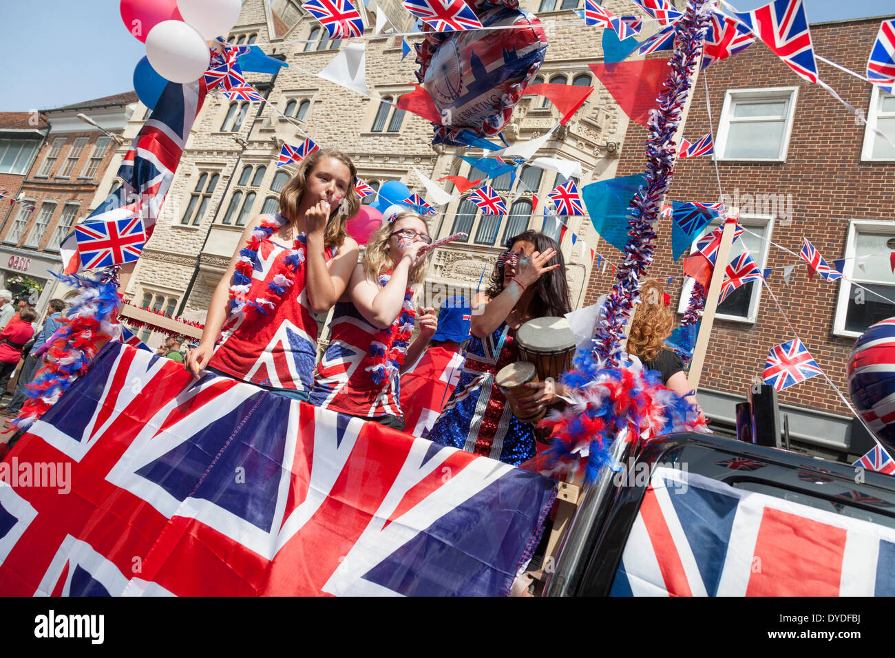 Girls in union Jack dress on float at  Chichester jubilee procession through the city centre to celebrate the Queen's Diamond Ju Stock Photo