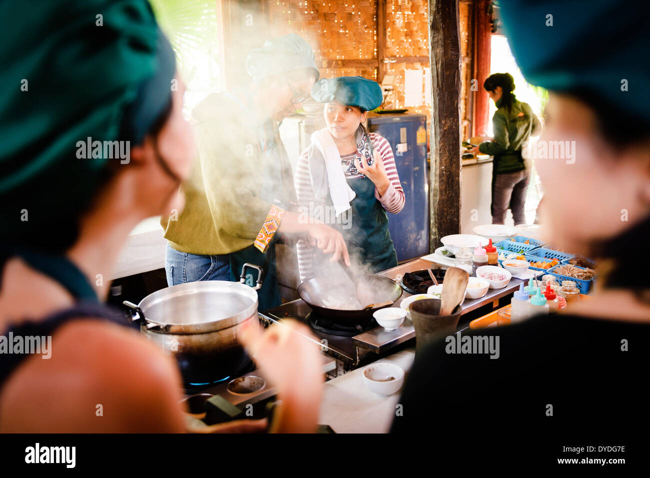 A tutor instructing a pupil at the Tum Tum Cheng Cooking School at Luang Prabang in Laos. Stock Photo
