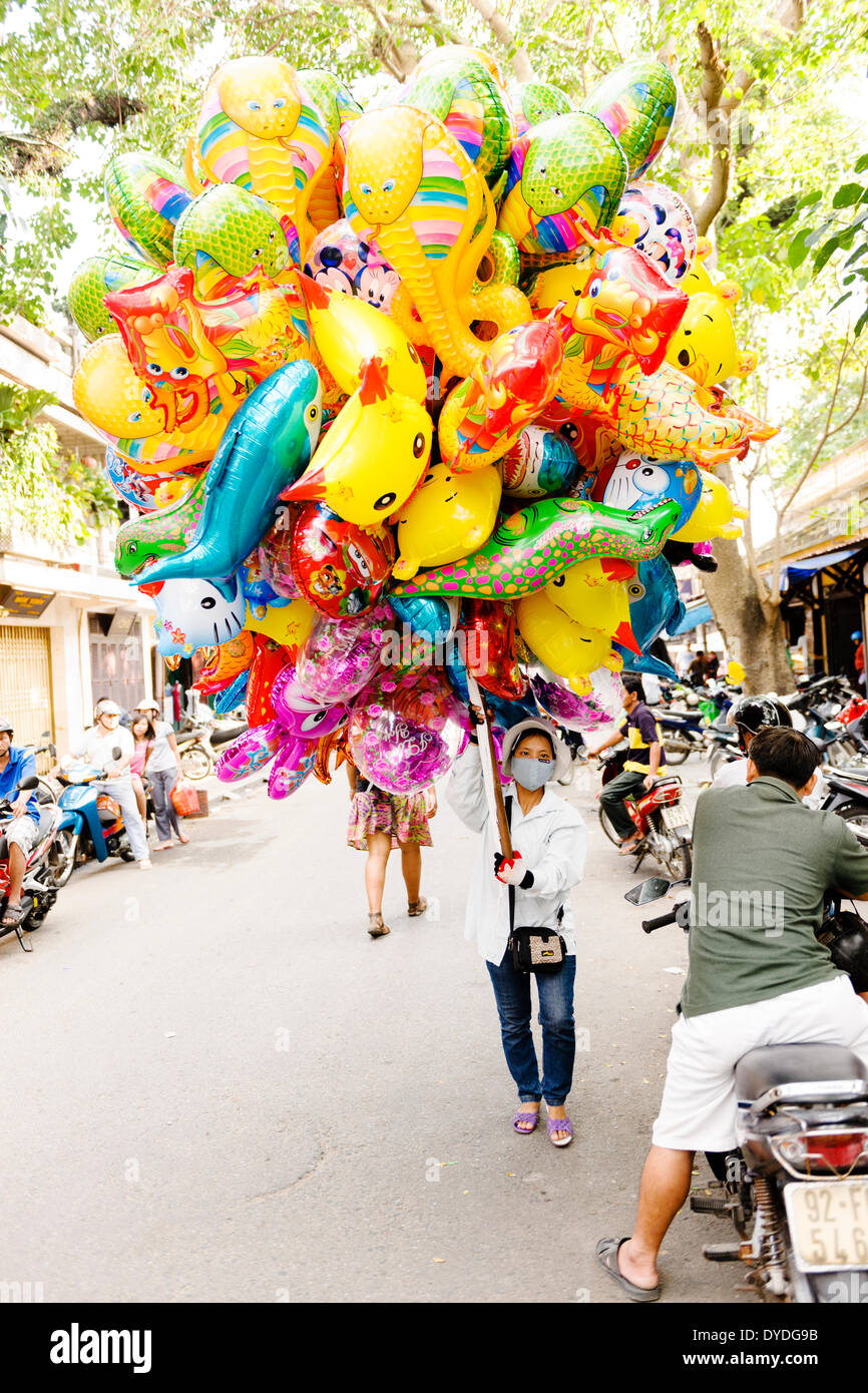 A balloon saleswoman at Hoi An market. Stock Photo