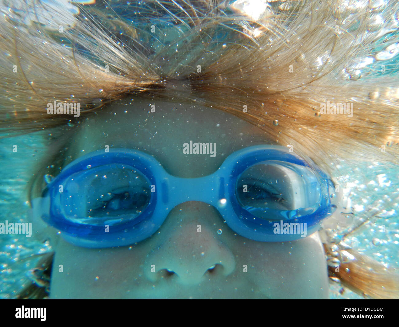 A boy swimming underwater. Stock Photo