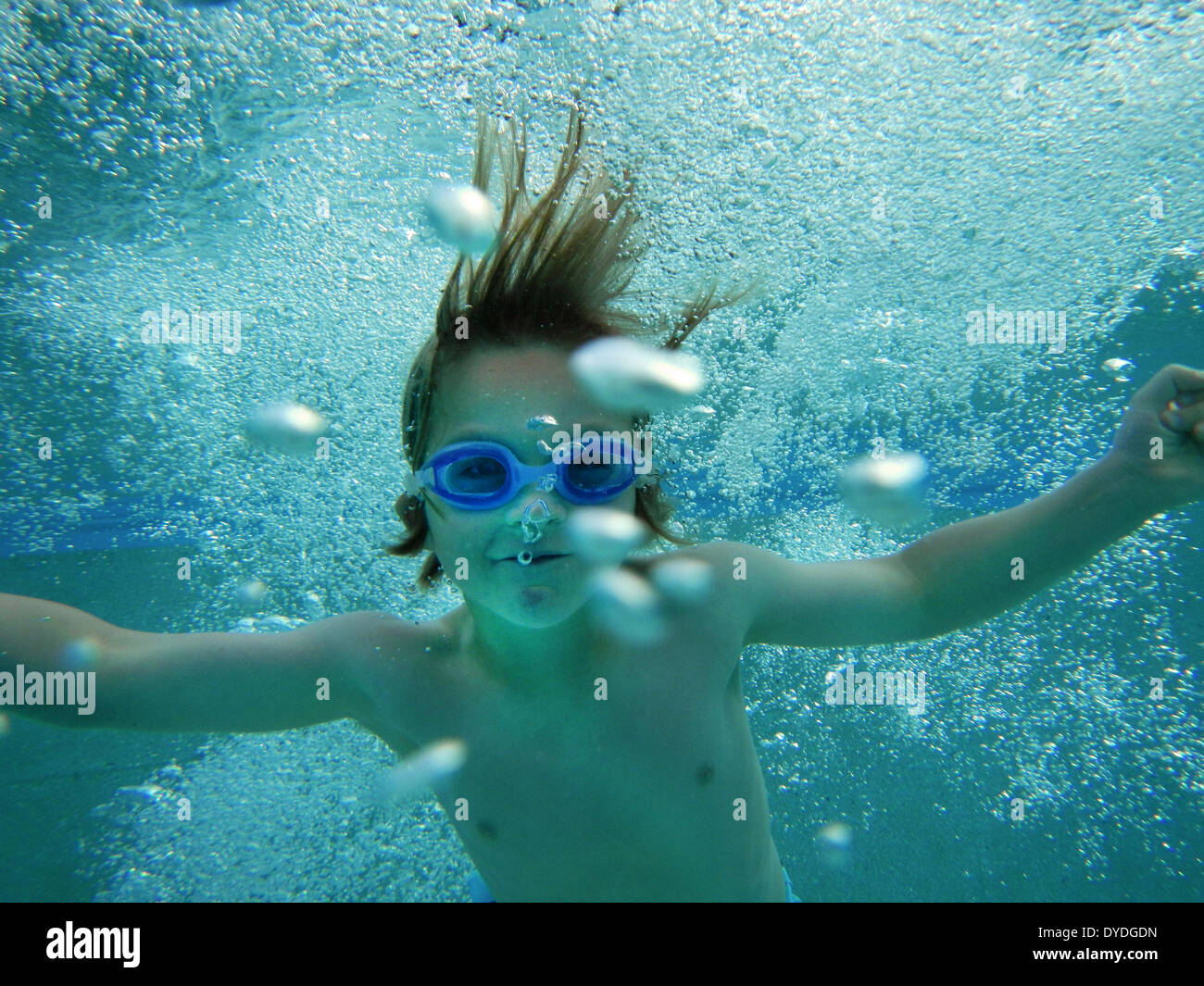 A boy swimming underwater. Stock Photo
