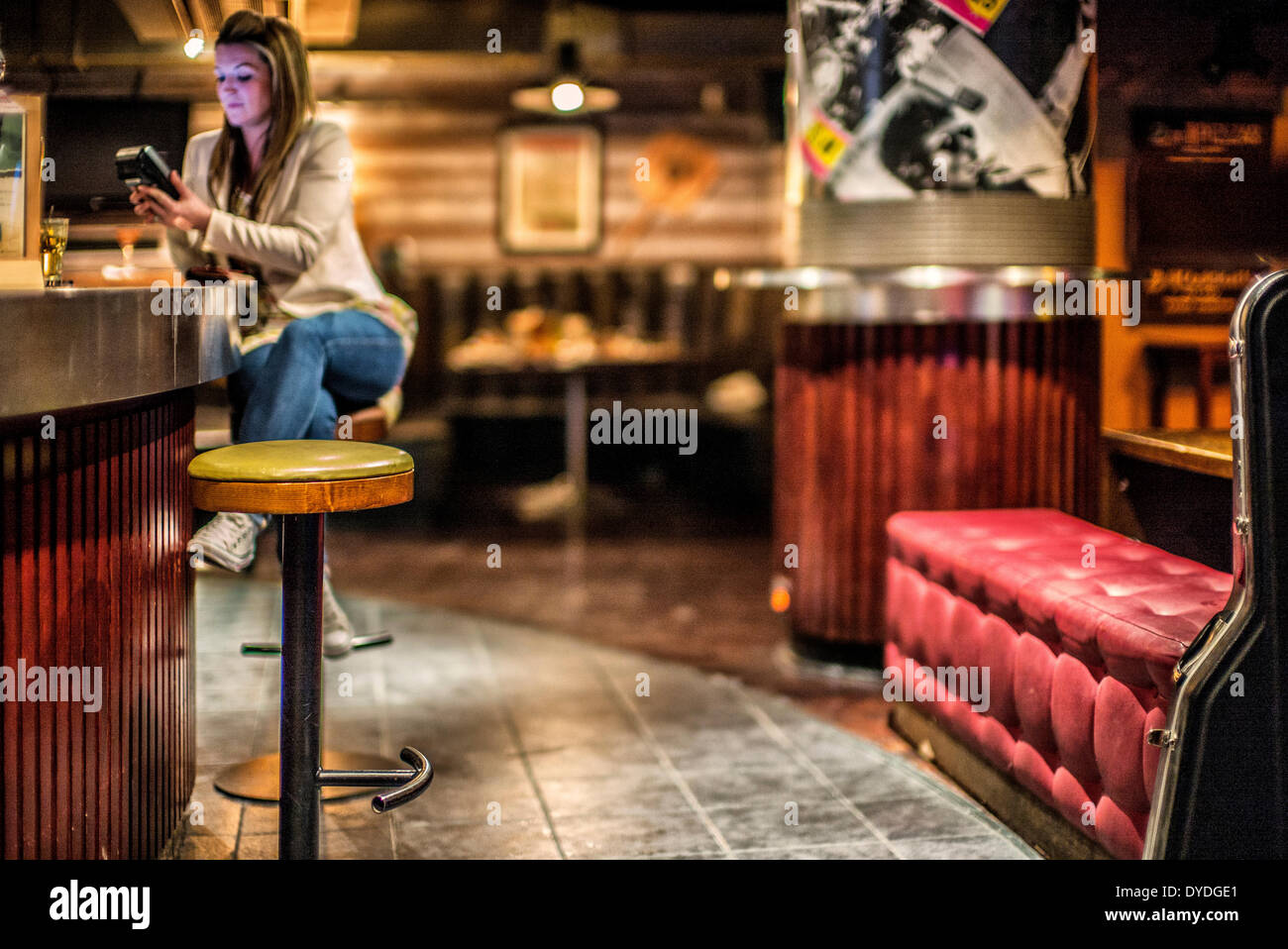 A girl paying by card in a bar. Stock Photo