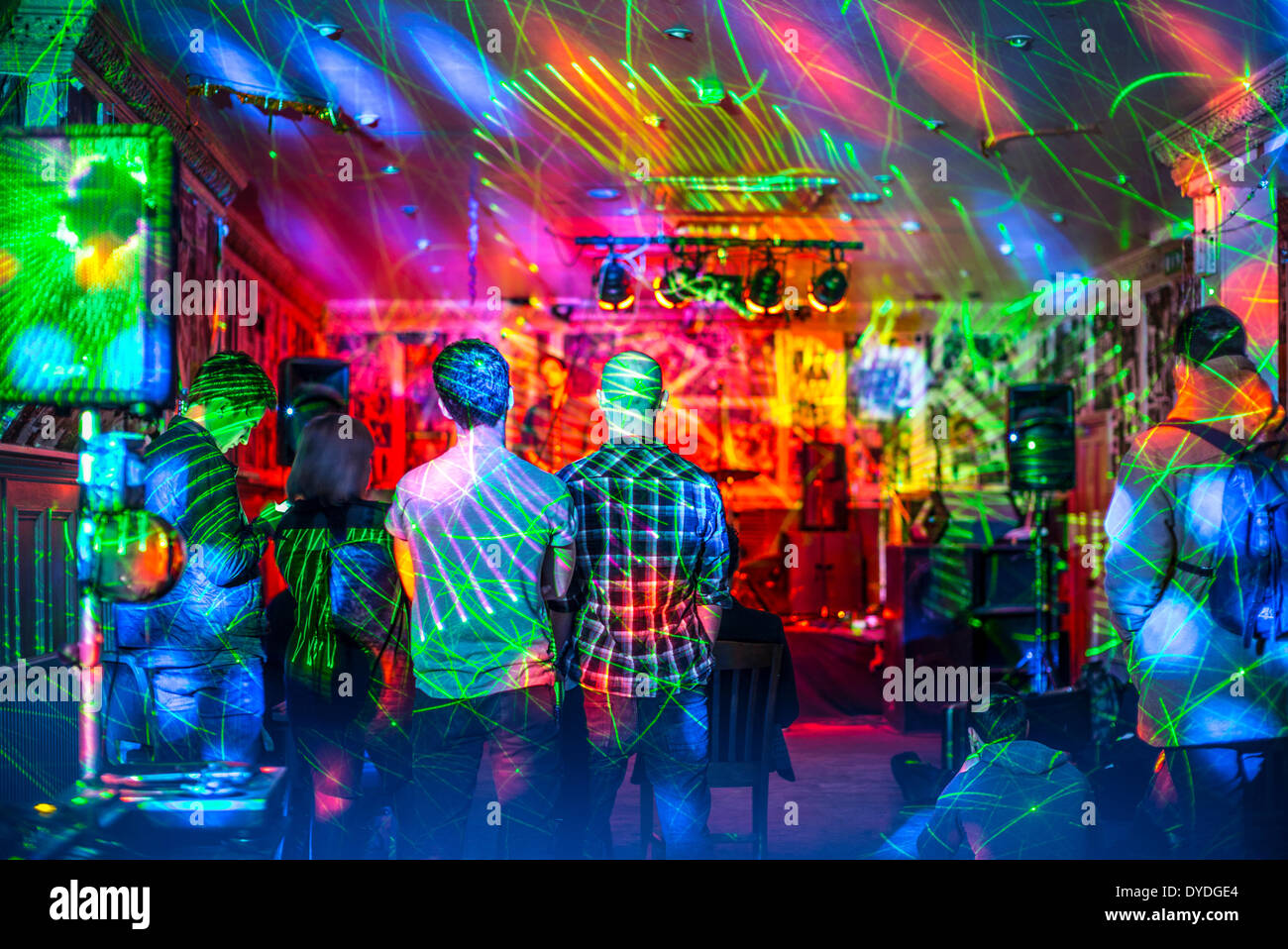 Watching a live performance in a small bar. Stock Photo