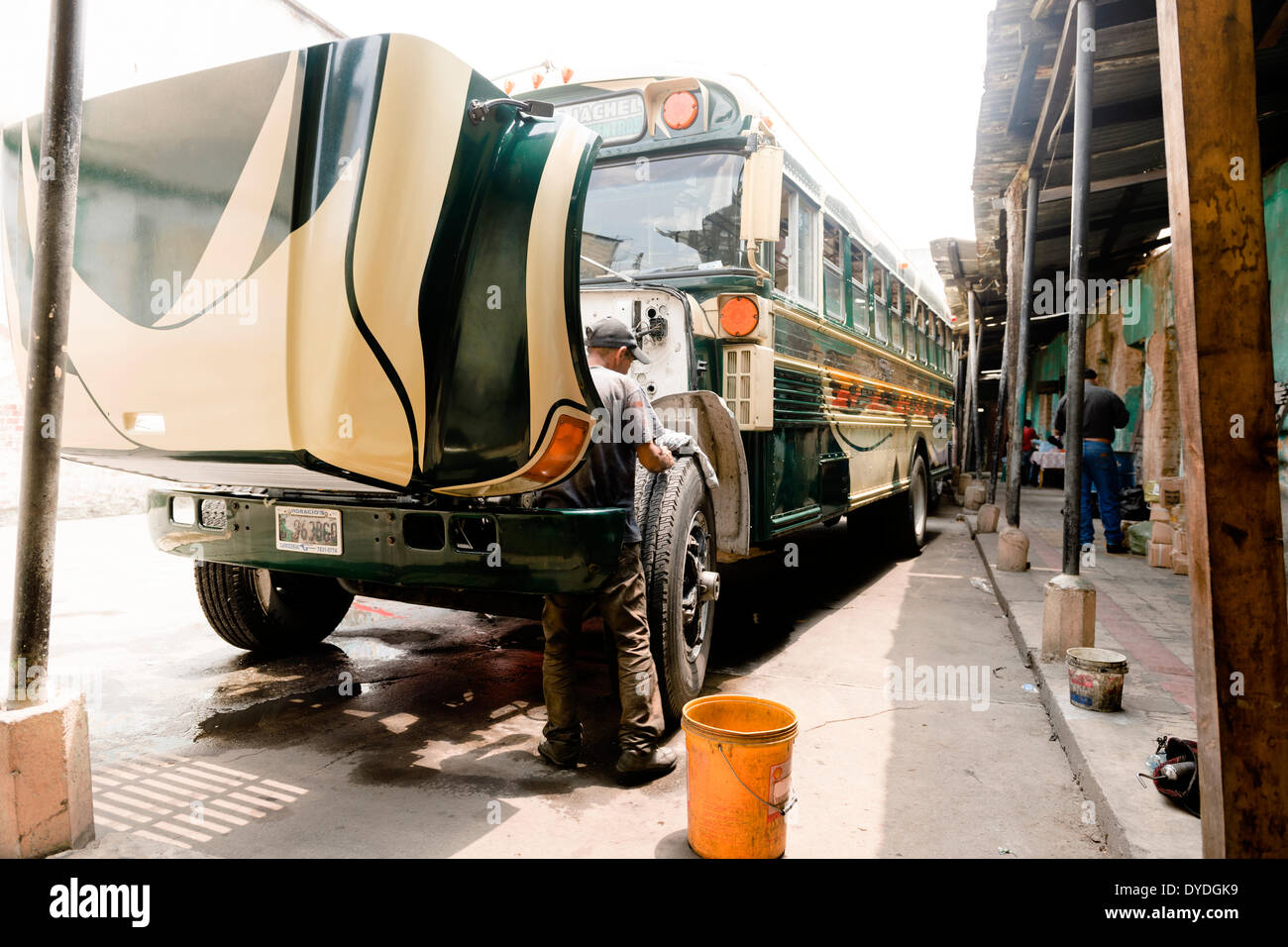 A chicken bus getting a good wash and overhaul at the depot before the journey from Guatemala City to Panajachel. Stock Photo