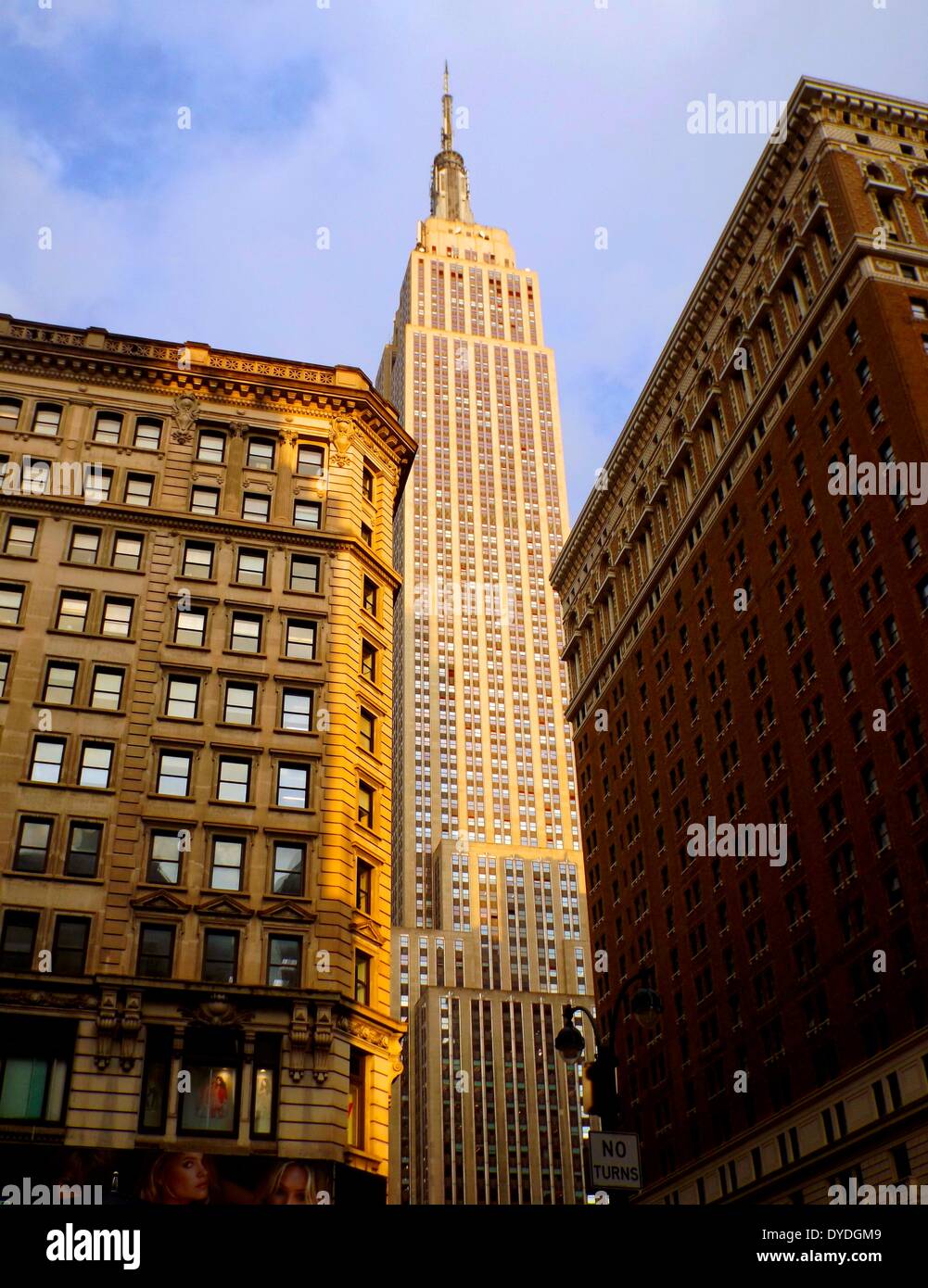 late nineteenth or early twentieth century apartments and offices, are sitting below the soaring Empire State Building, New York City Stock Photo