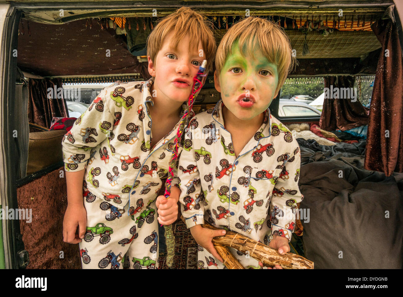 Two boys having fun in a VW camper van  at a festival. Stock Photo