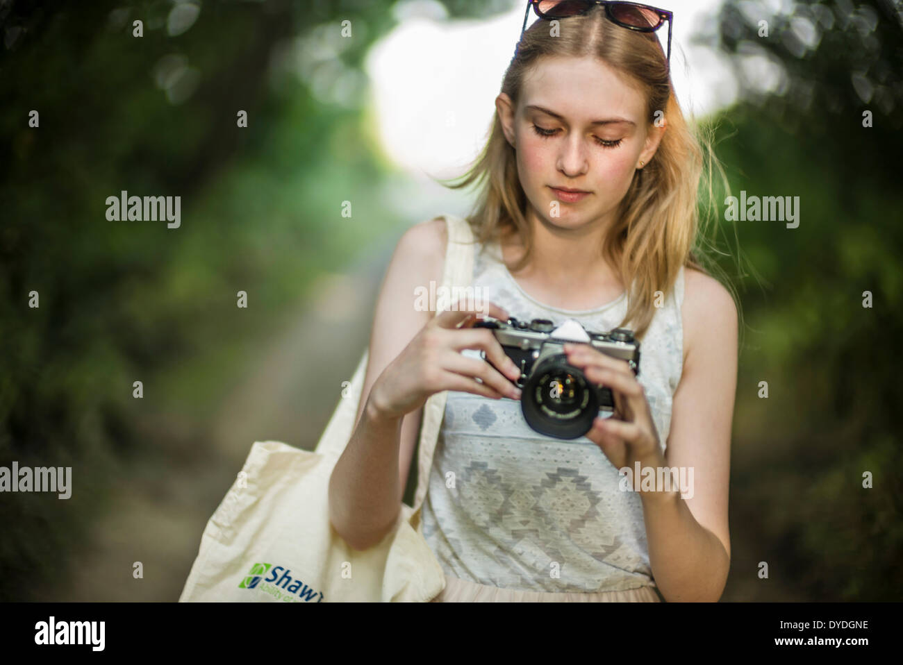 A young girl with a film camera. Stock Photo