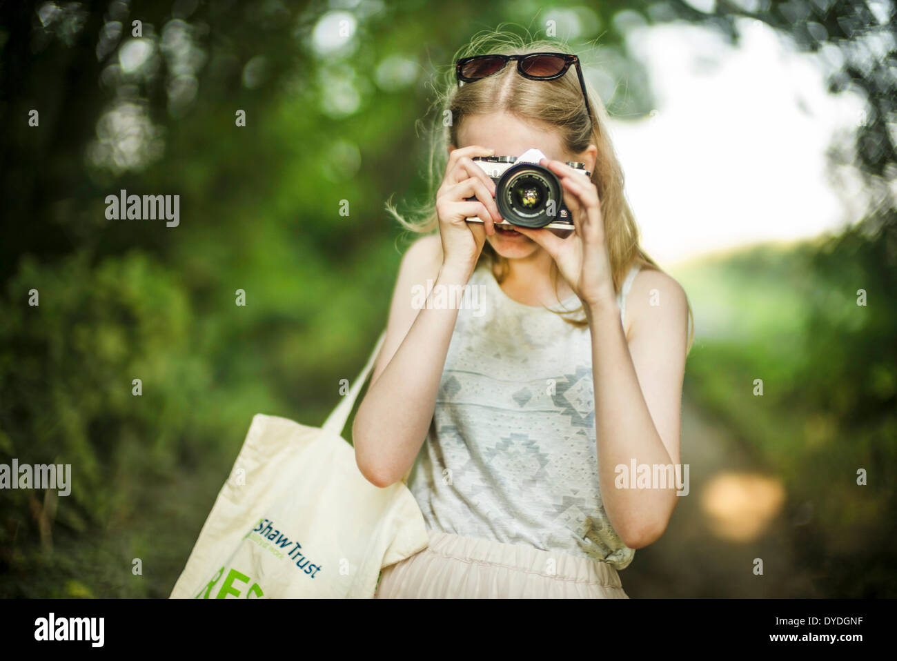 A young girl with a film camera. Stock Photo