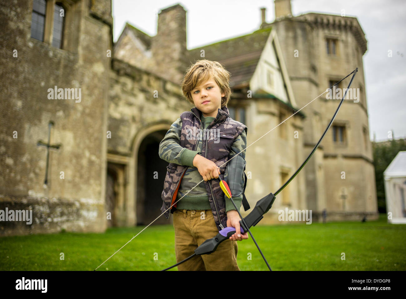 A young boy in Thornbury Castle garden playing archery. Stock Photo