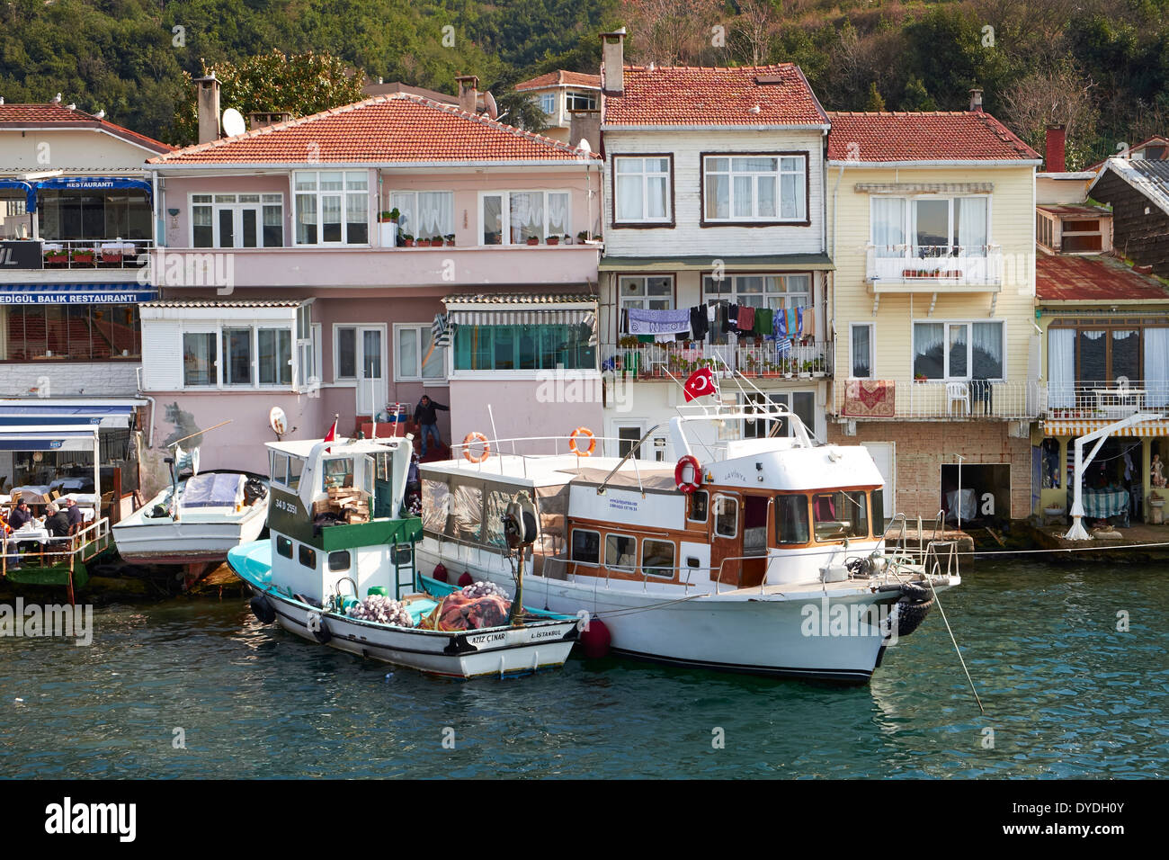 Turkish homes and boats on the Bosphorus Strait, Istanbul in Turkey. Stock Photo