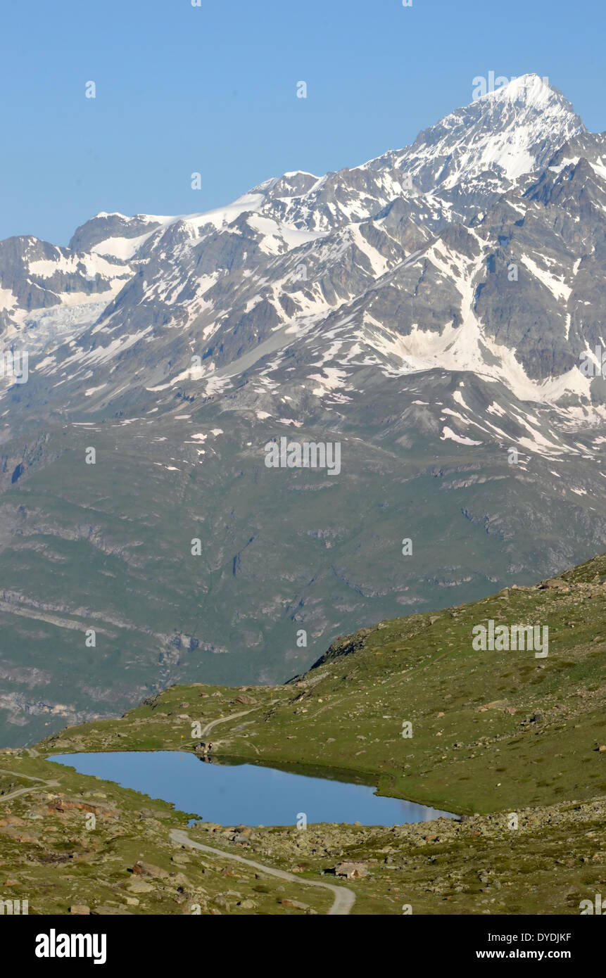 alps mountains snow lake water reflexion walkers hikers hiking path route leisure vacation sport exercise mountainous alpi Stock Photo