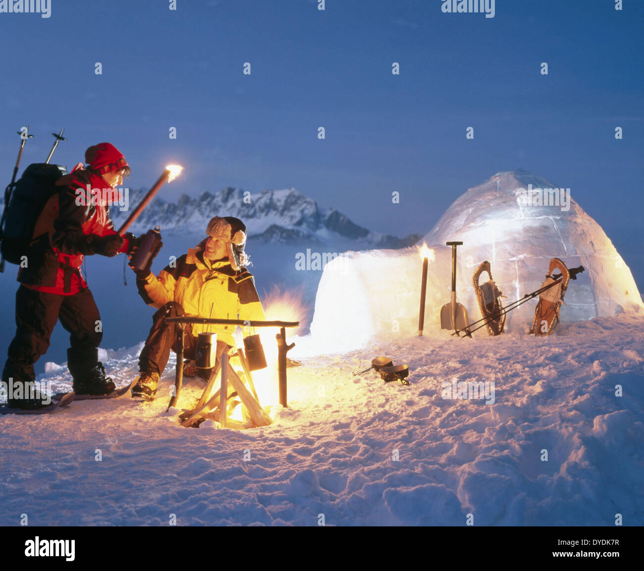 adventure alpine canton St. Gall igloo campfire at night couple Pizol snow Switzerland Europe Switzerland winter sports Stock Photo