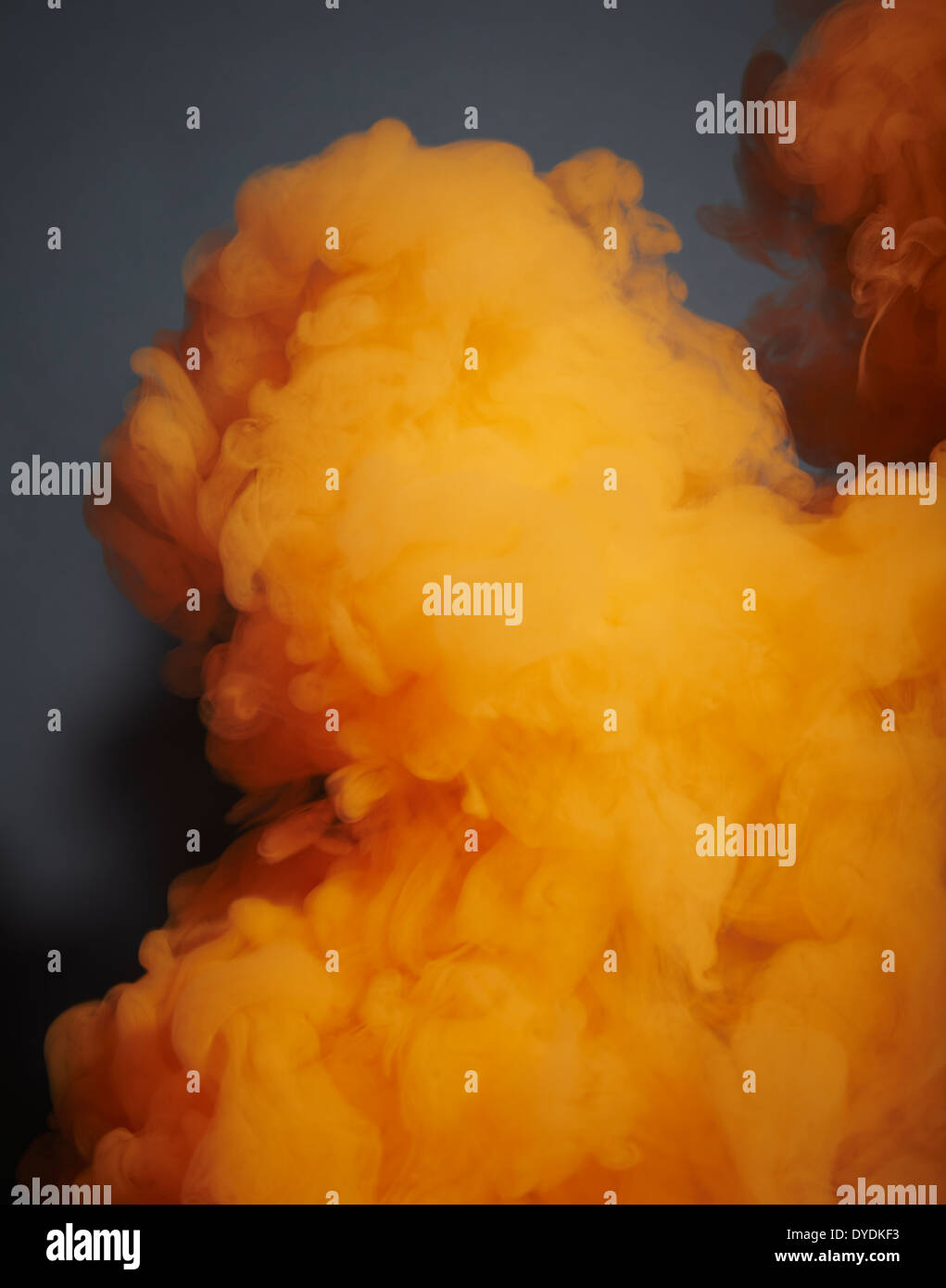 orange smoke photographed against a grey background Stock Photo Alamy