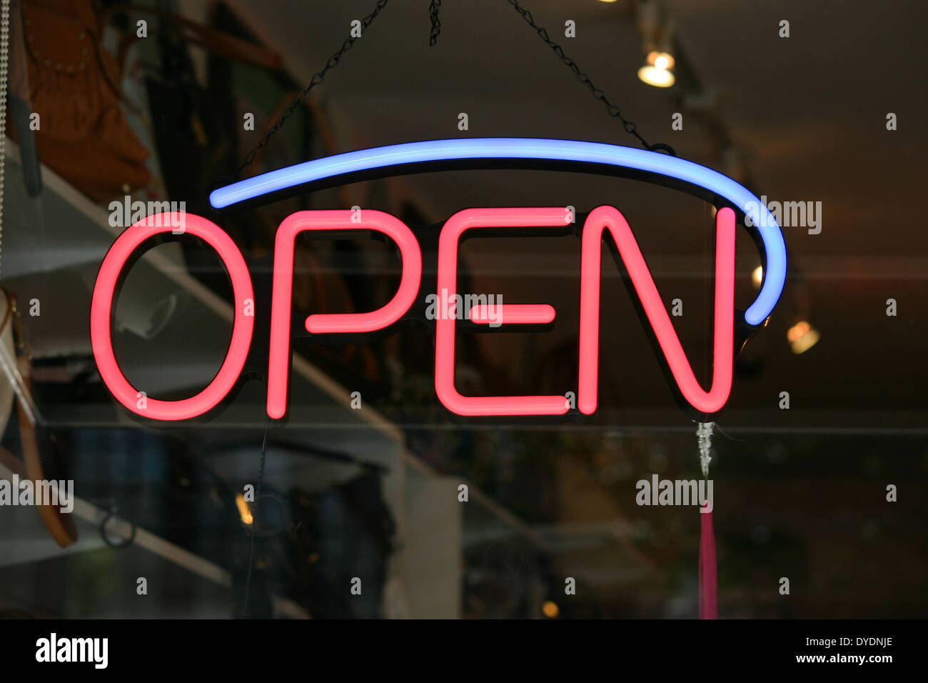 A red and blue open sign in the window of a store Stock Photo