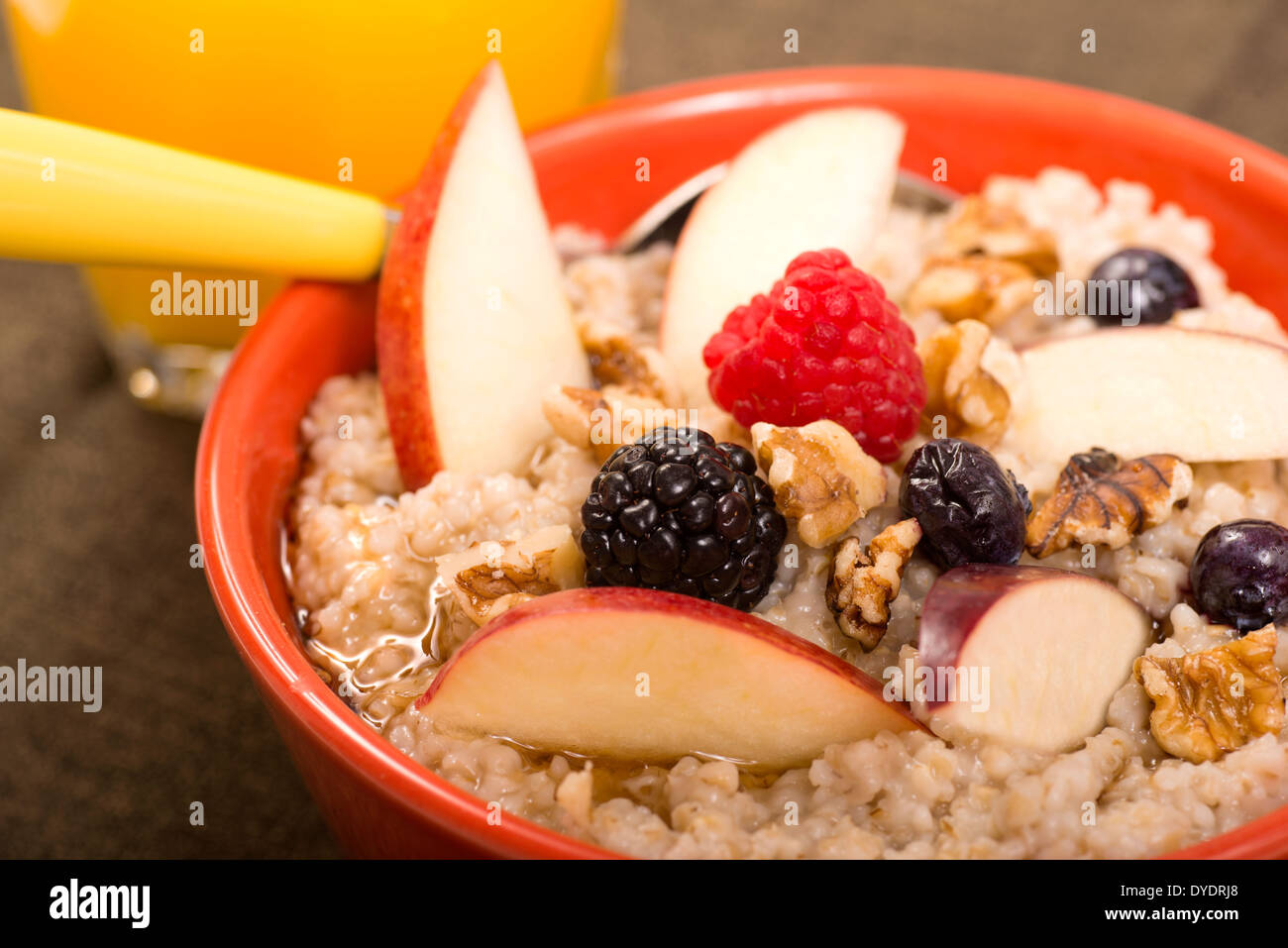 Bowl of steel cut oats served with fresh fruit and honey Stock Photo