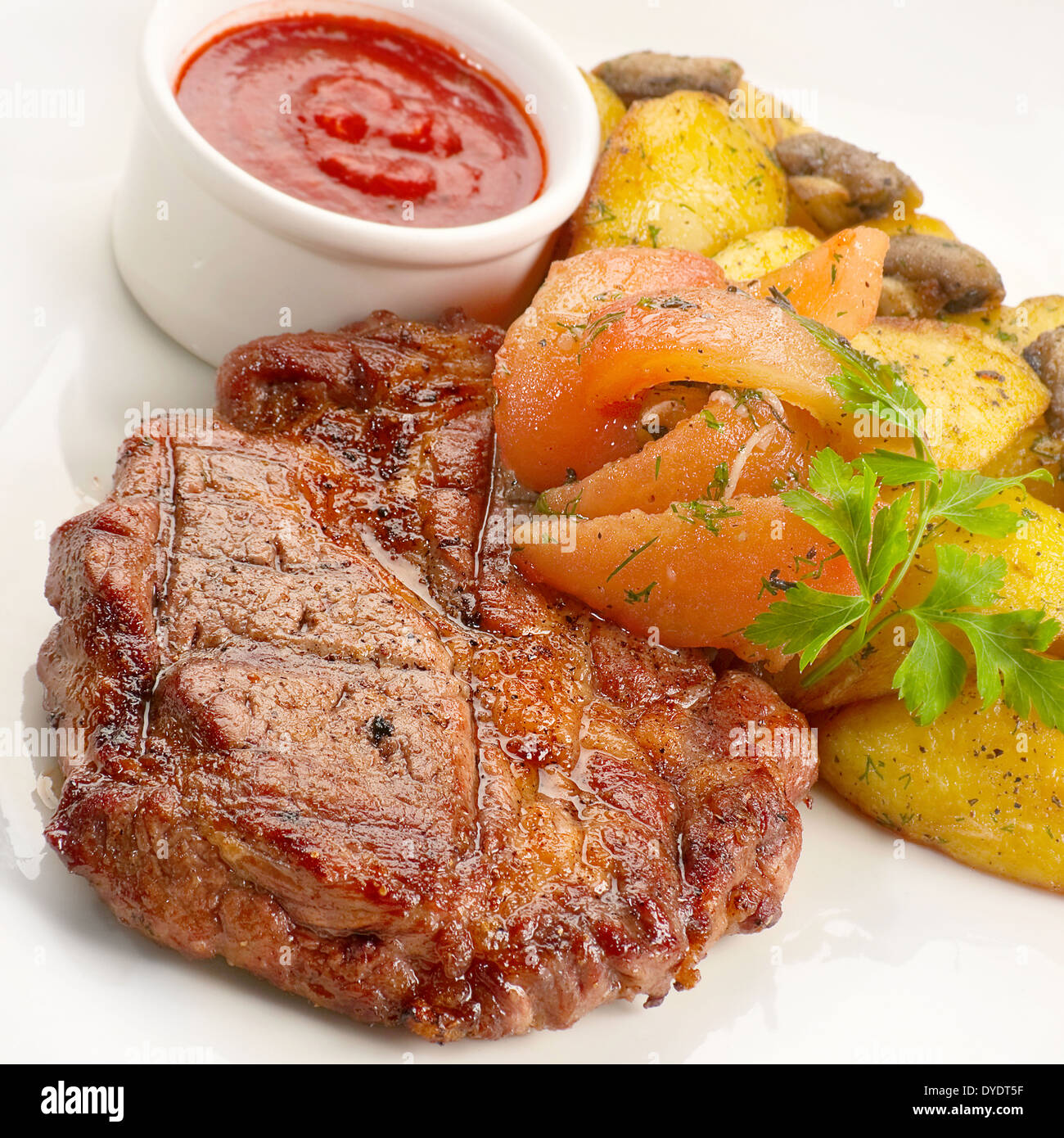 Fried veal steak with potato and sauce Stock Photo
