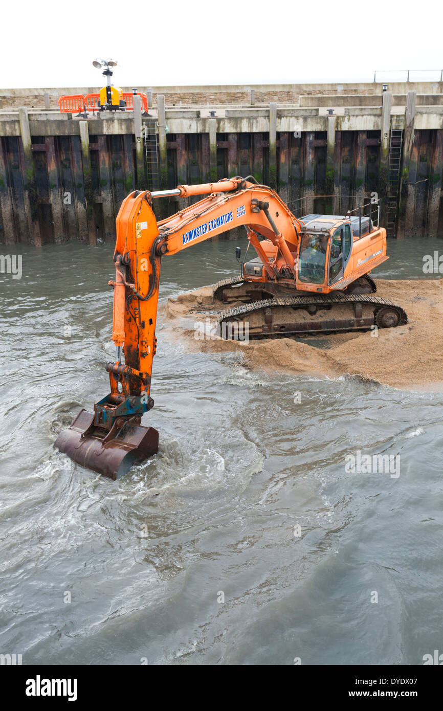 Dredging operations to clear the harbour after the winter storms at West Bay, Bridport, Dorset UK Stock Photo