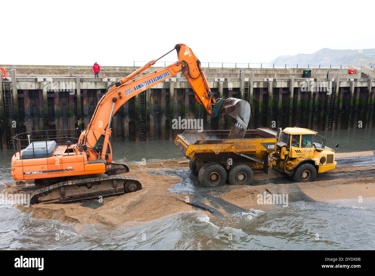 Dredging operations to clear the harbour after the winter storms at West Bay, Bridport, Dorset UK Stock Photo
