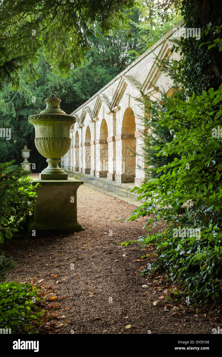 William Kent's seven-arched arcade beside two classical urns in the landscaped gardens of Rousham House, Oxfordshire, England Stock Photo