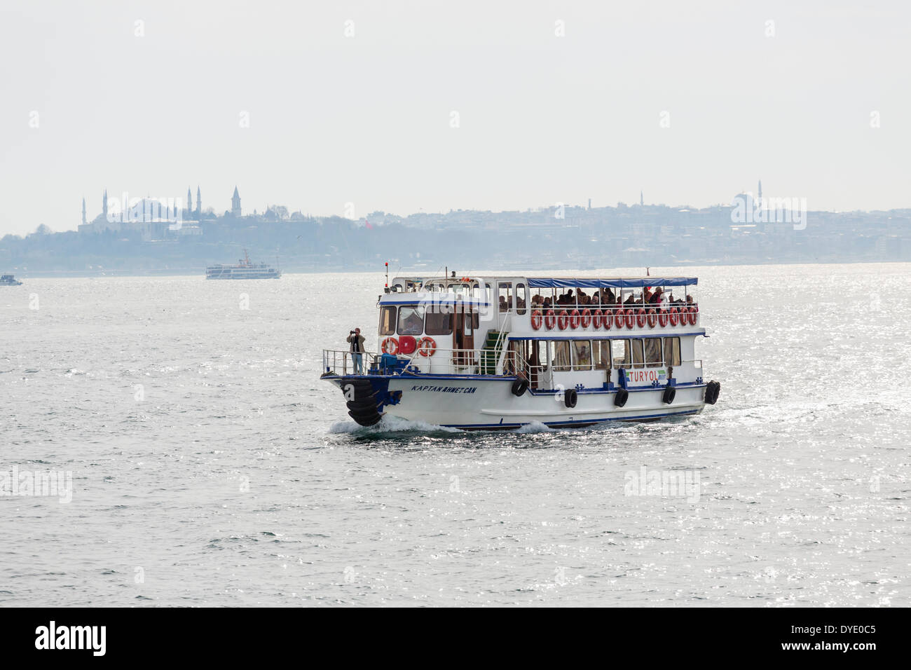 Cruise boat on the Bosphorus with Sultanahmet and Eminonu behind, Istanbul, Turkey Stock Photo