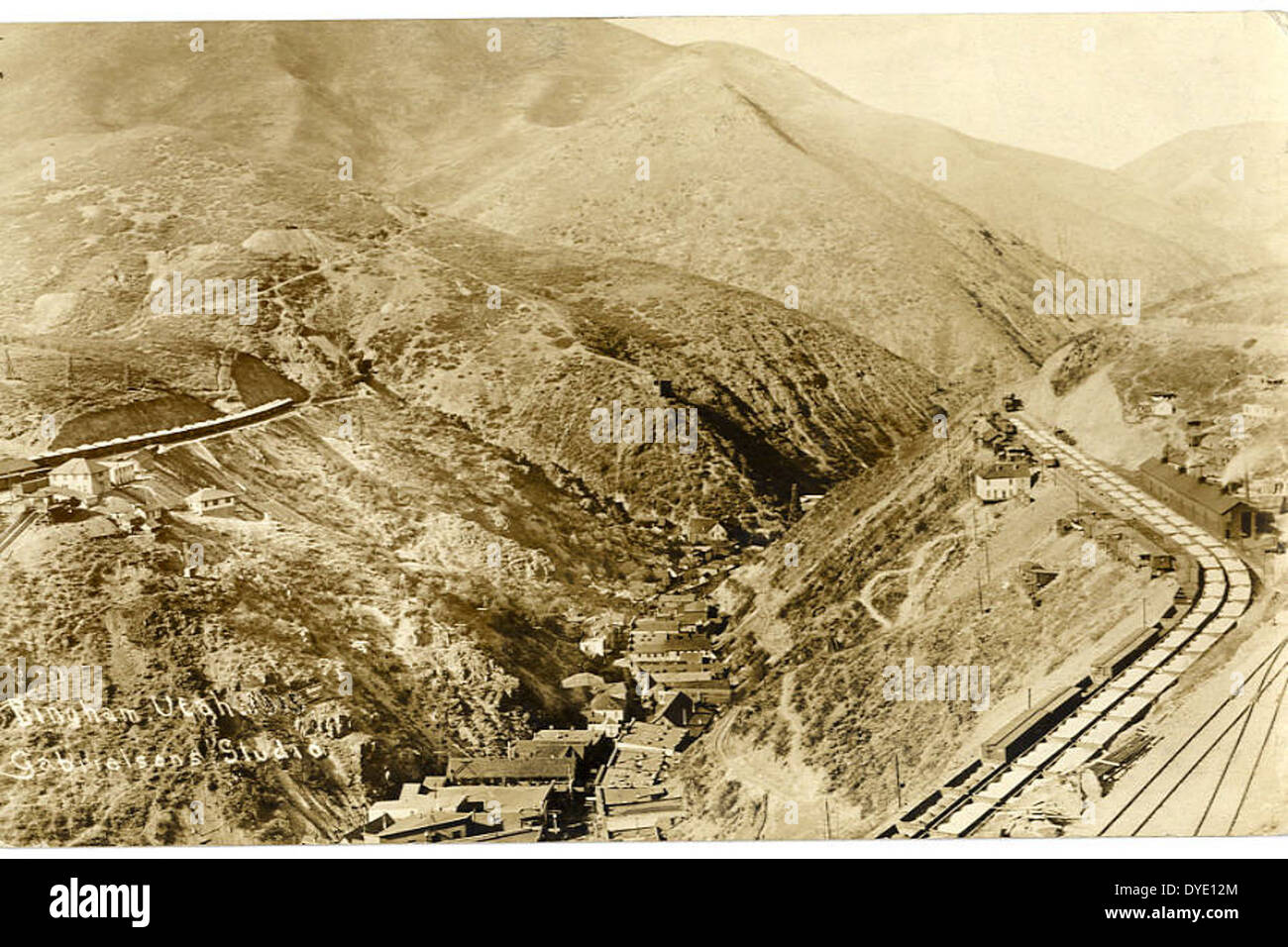 This aerial view of Bingham, Utah, captures the town and surrounding landscape, including the nearby mountains. The image offers a bird’s-eye perspective of the region, showcasing both urban and natural elements of the area. Stock Photo