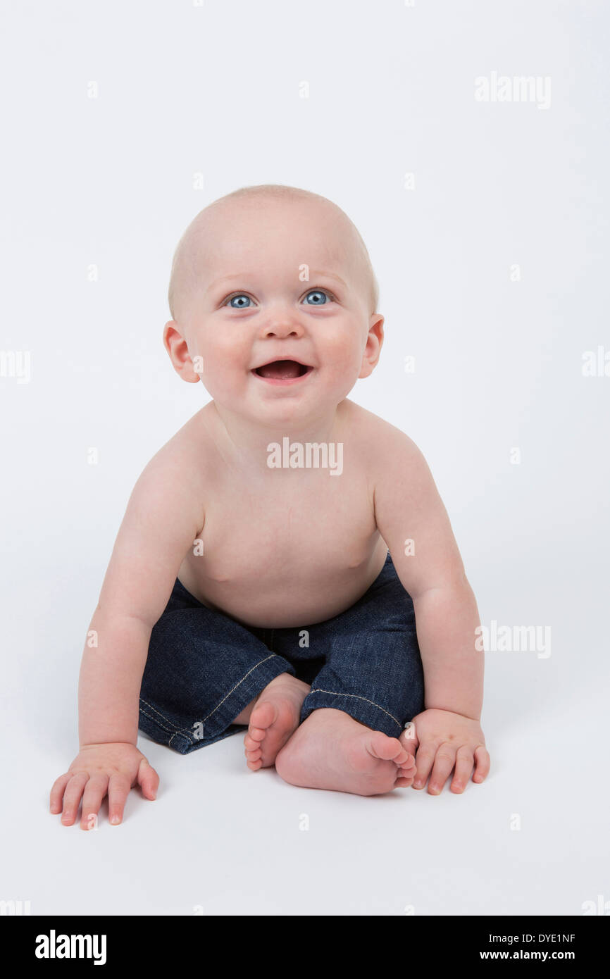 Happy Smiling 6 month old Baby Boy Wearing Blue Jeans Stock Photo - Alamy