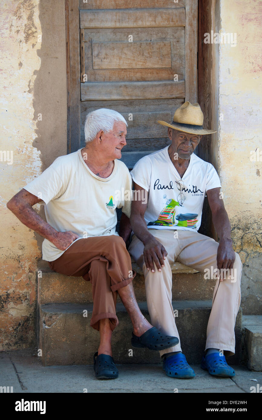 Two seated men outside house Trinidad Sancti Spiritus Province Cuba Stock Photo