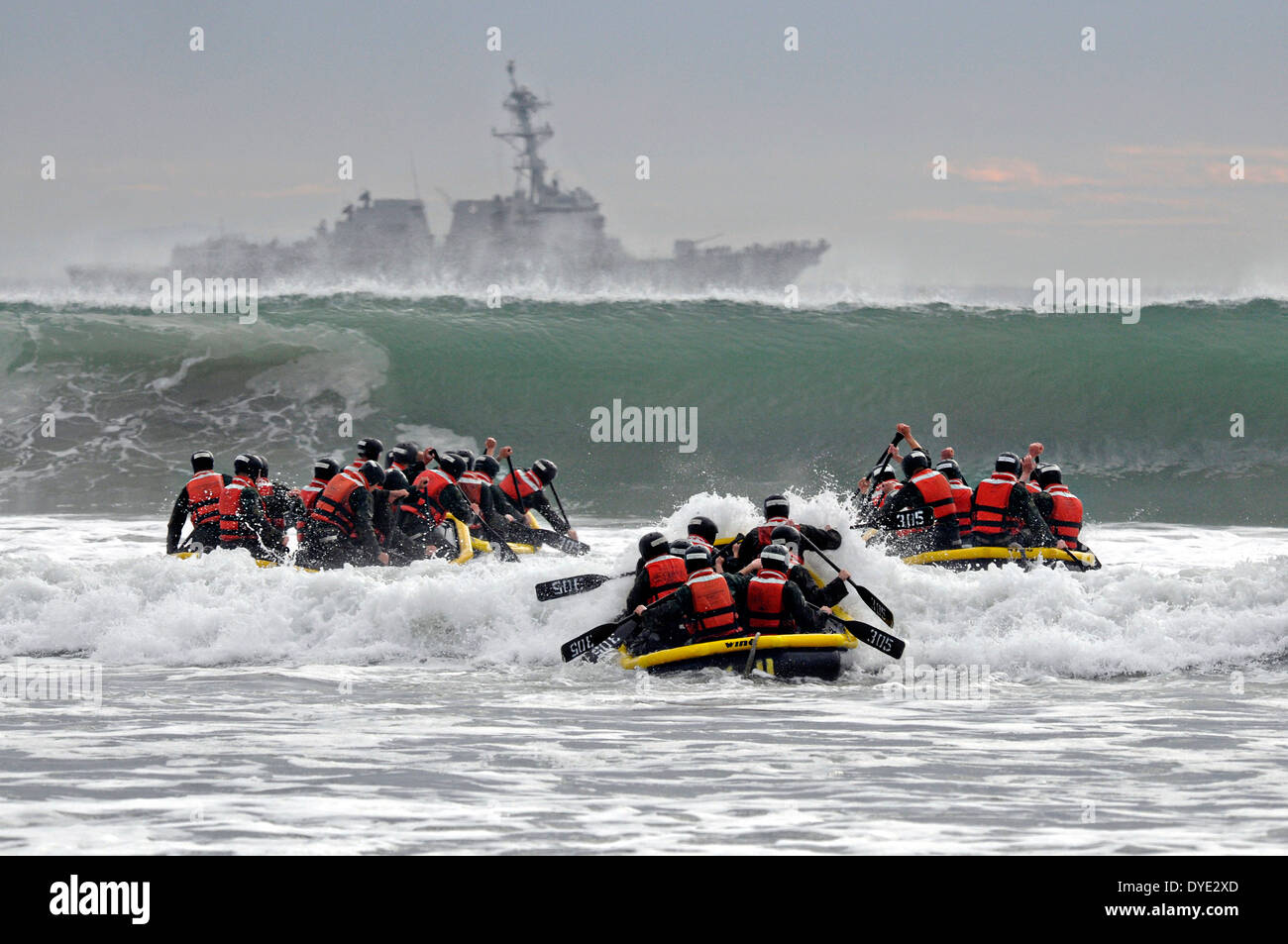 US Navy SEAL team candidates paddle into the high waves ...