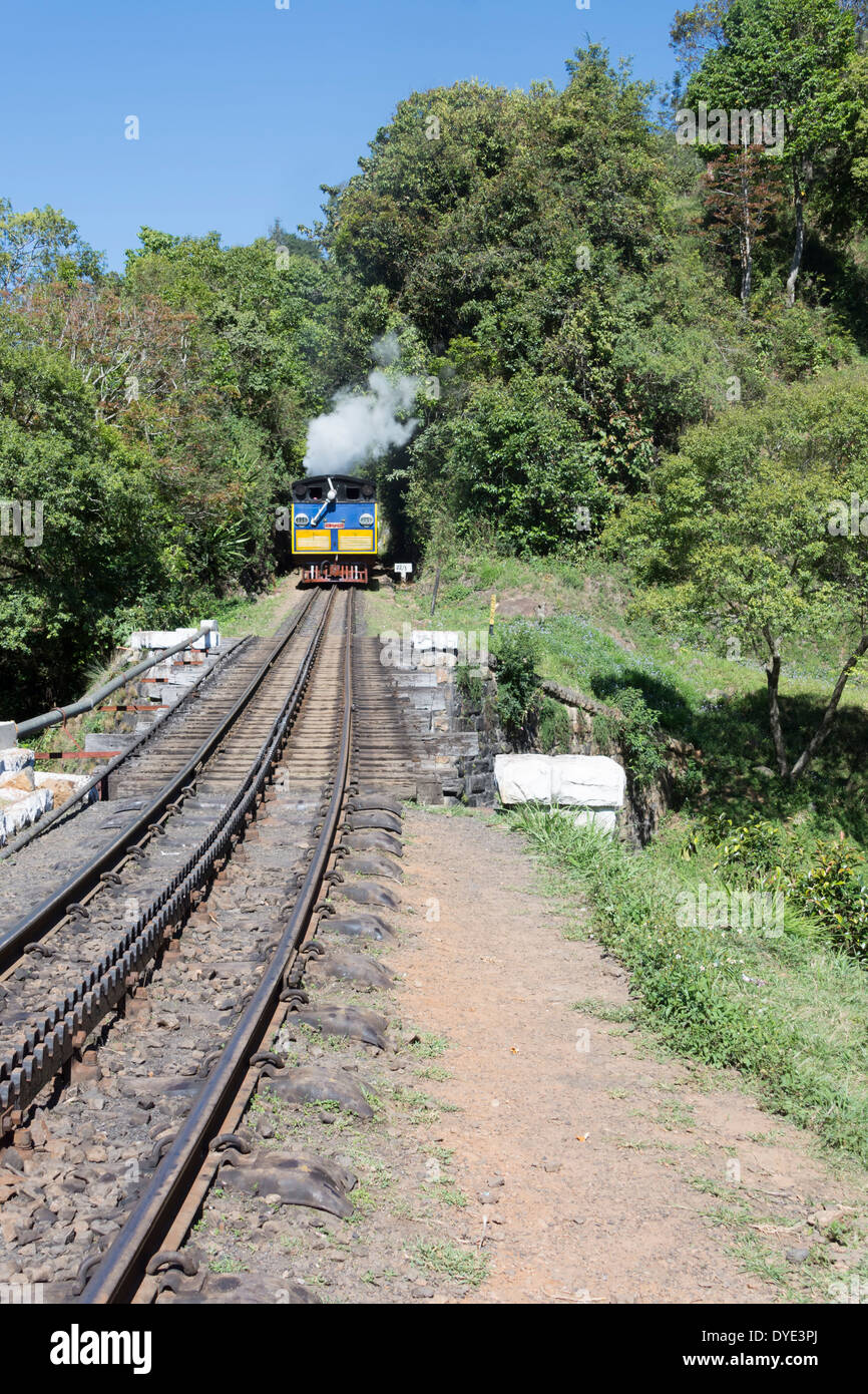 A Nilgiri Mountain Railway steam train makes progress through the Nilgiri Hills, Tamil Nadu, India Stock Photo