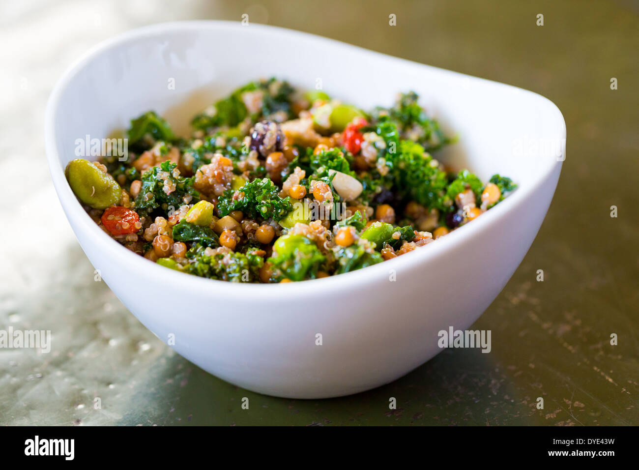 Raw paleo quinoa kale salad in a bowl. Healthy eating diet food. Stock Photo
