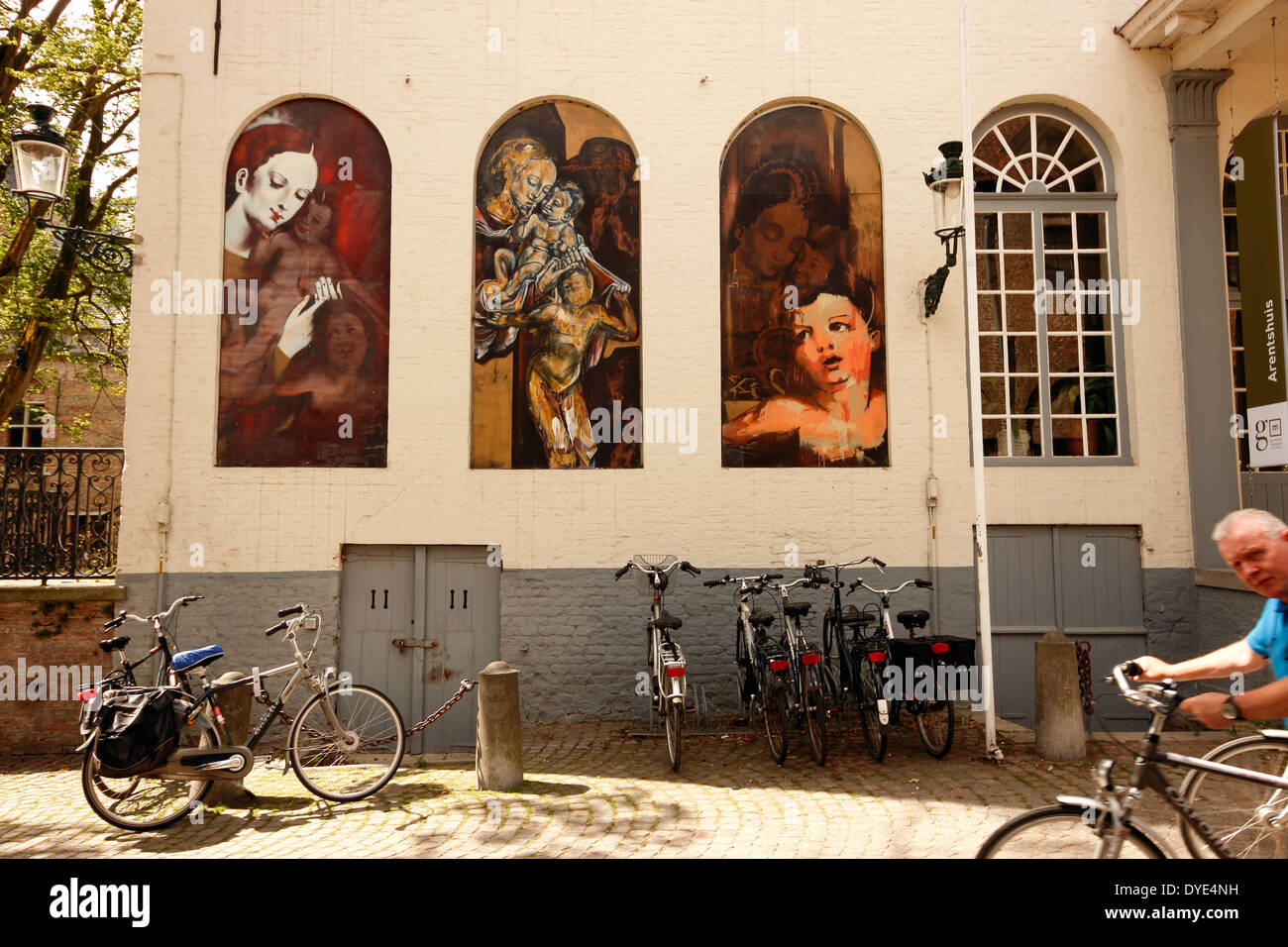 Bicycles under the exterior murals of the Groeningemuseum, Bruges, Belgium Stock Photo